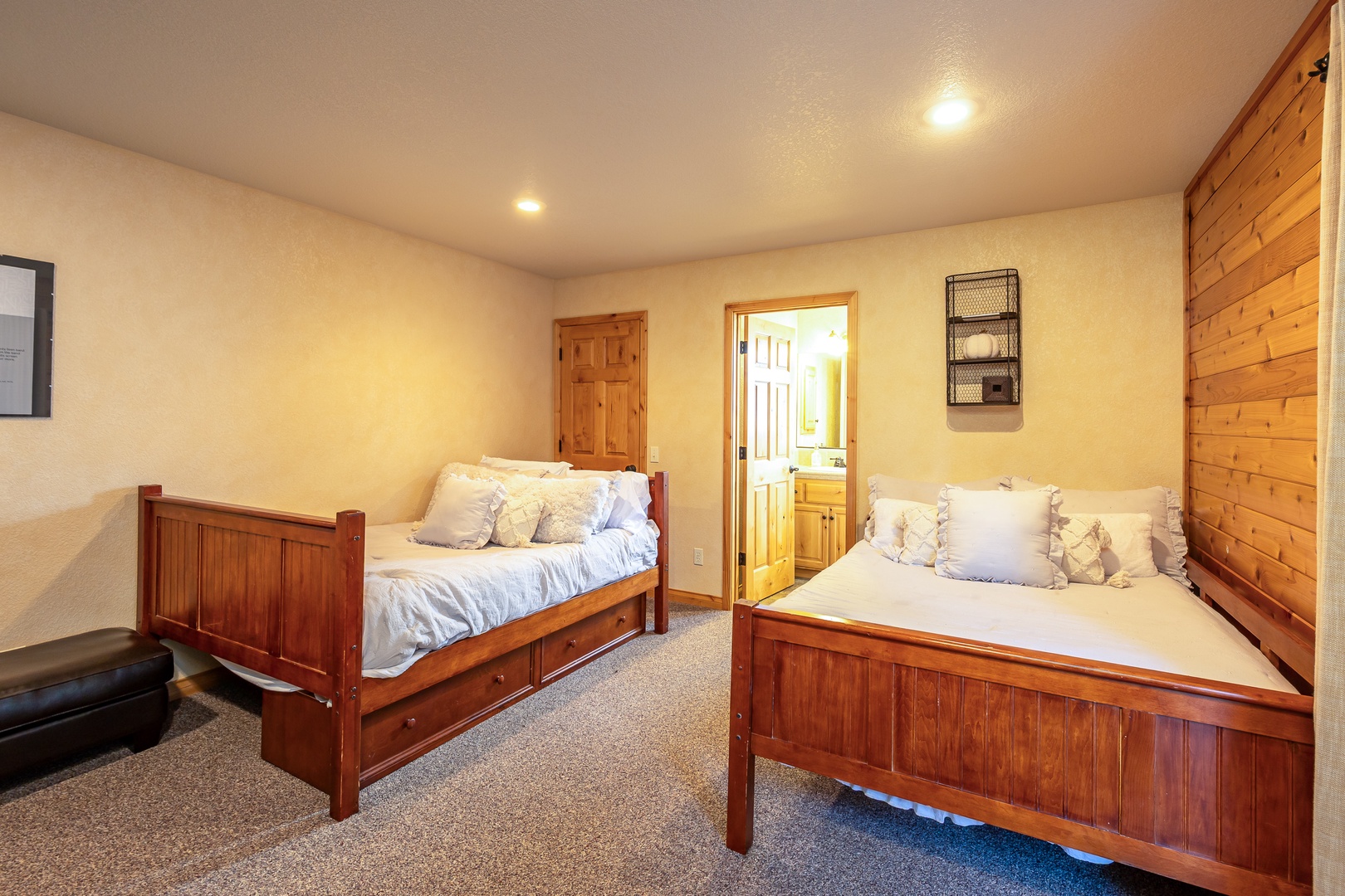 Unwind in your cozy twin bedroom featuring handcrafted wooden beds with crisp linens and rustic charm for a restful night's sleep.