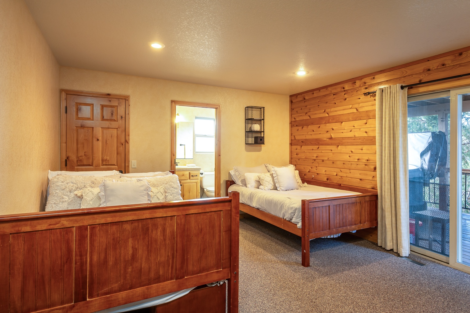 Rest easy in this charming twin bedroom with beautiful wood accents and direct balcony access for morning coffee.