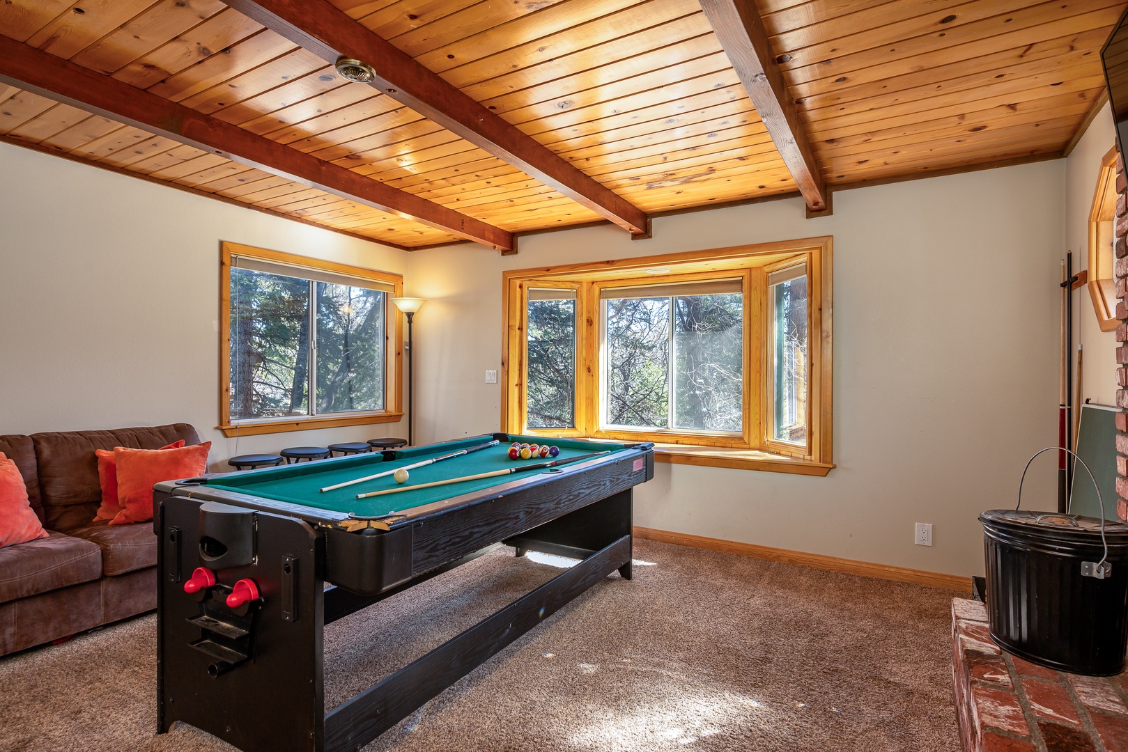 Challenge friends to a game of pool in your private game room, where exposed wood beams and natural light create the perfect atmosphere for fun.