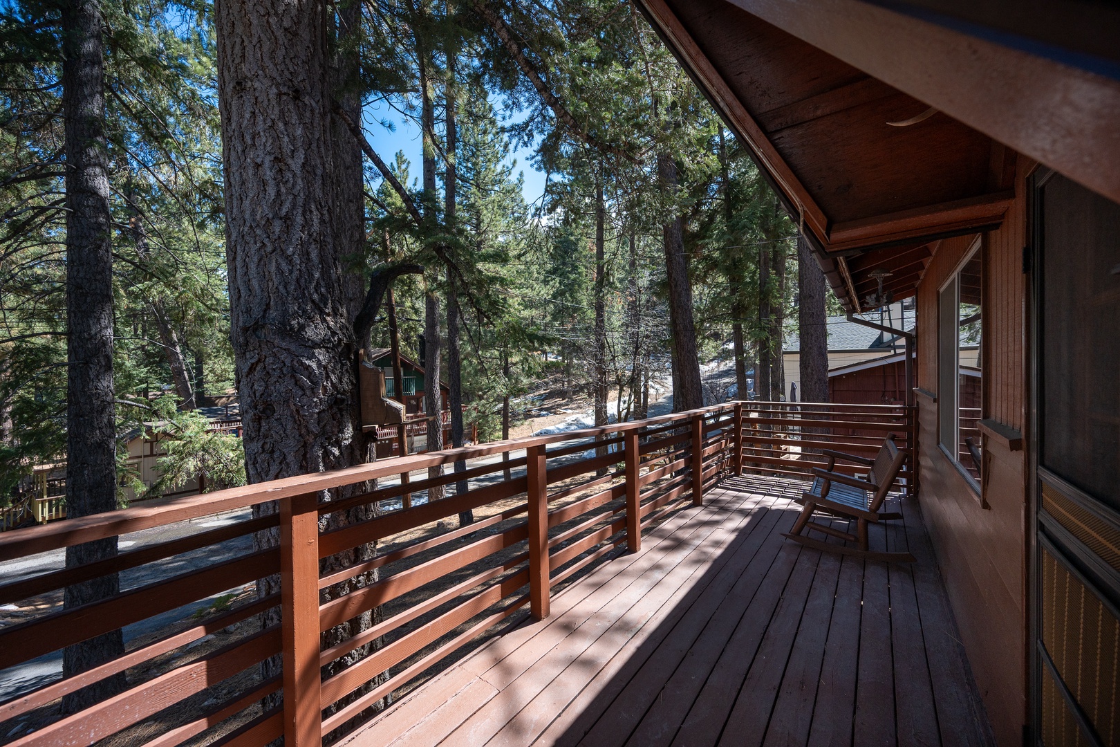 Step onto your private deck and breathe in the crisp forest air, surrounded by towering pines. Enjoy morning coffee or evening relaxation in this peaceful, sun-dappled woodland retreat.
