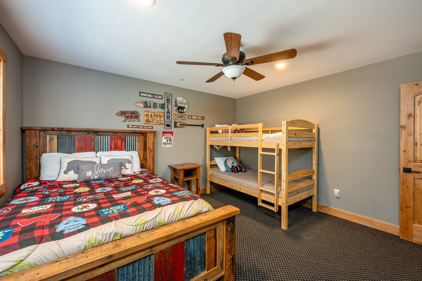 Your spacious bedroom features a cozy queen bed with rustic charm and sturdy bunk beds—perfect for families or groups seeking mountain lodge comfort together.