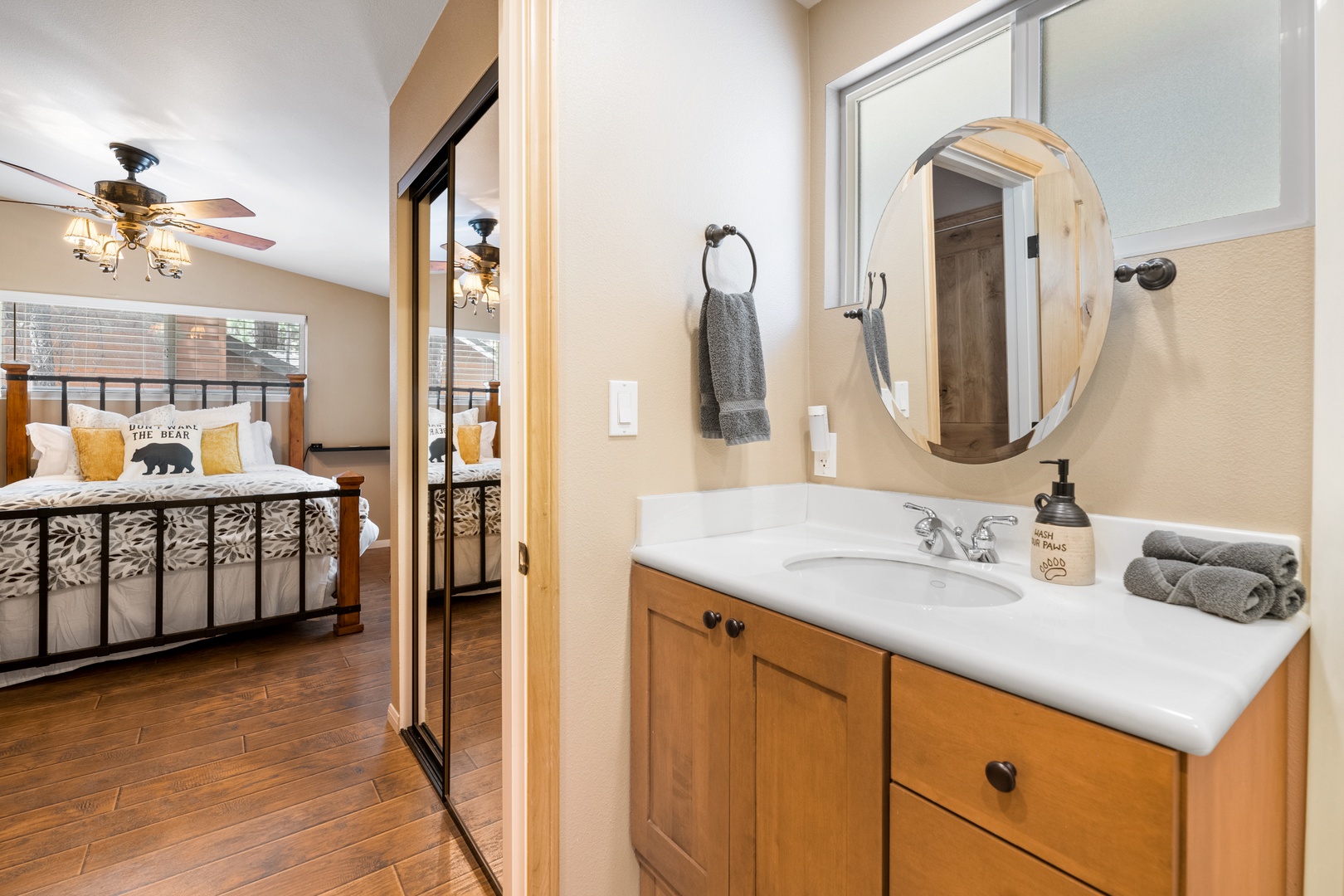 Step into your private bathroom where warm woods meet mountain charm, complete with fresh towels and thoughtful touches for your stay.