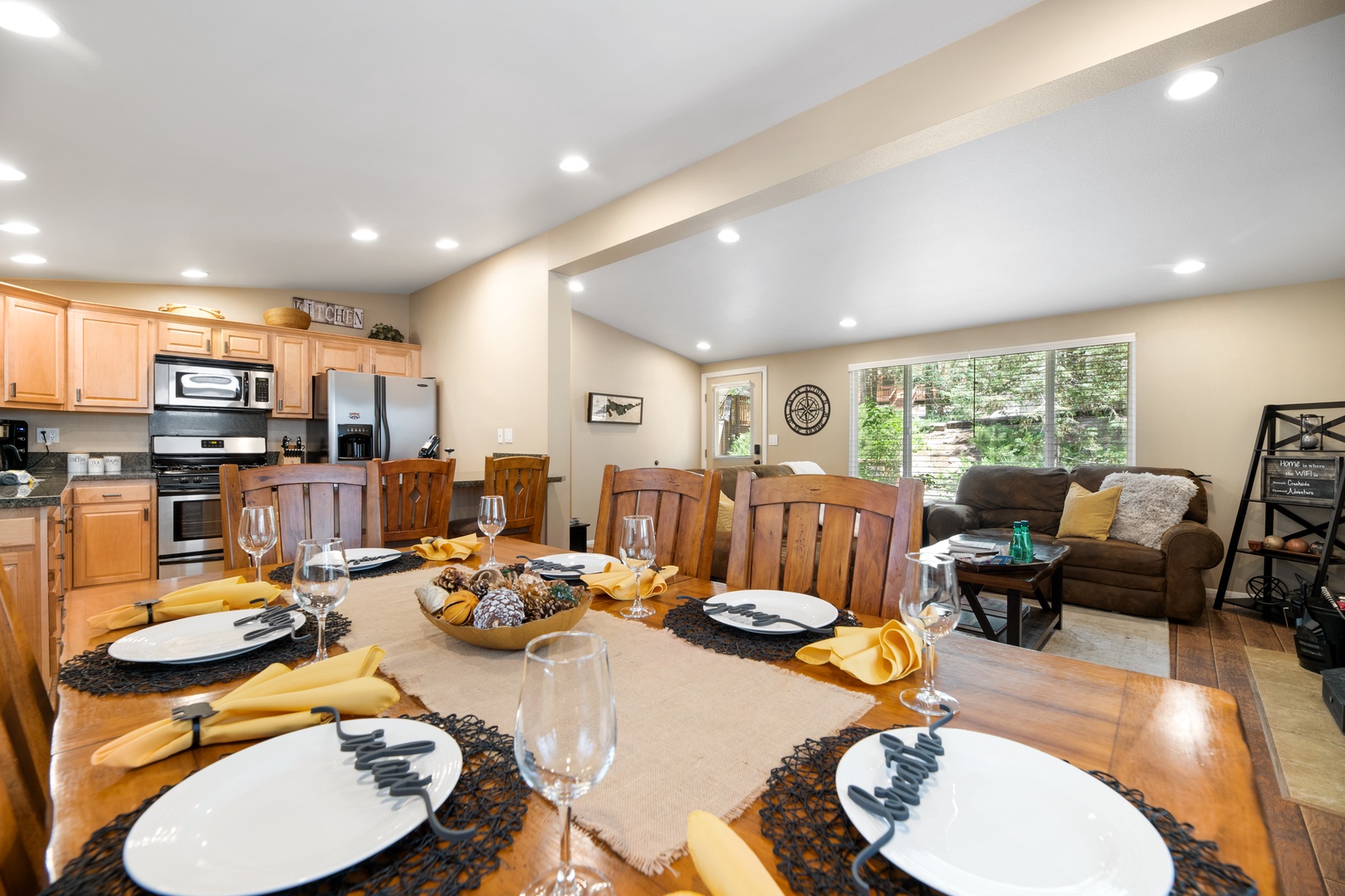 Gather around this welcoming dining table for memorable meals with your group. The open layout flows into a cozy living area and fully-equipped kitchen, creating a warm space for connection and relaxation.