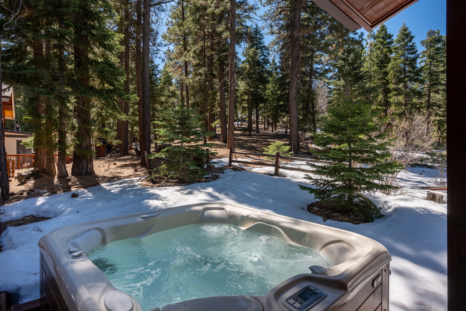 Soak in the bubbling hot tub surrounded by towering pines and fresh mountain air, where winter's serene beauty becomes part of your private escape.