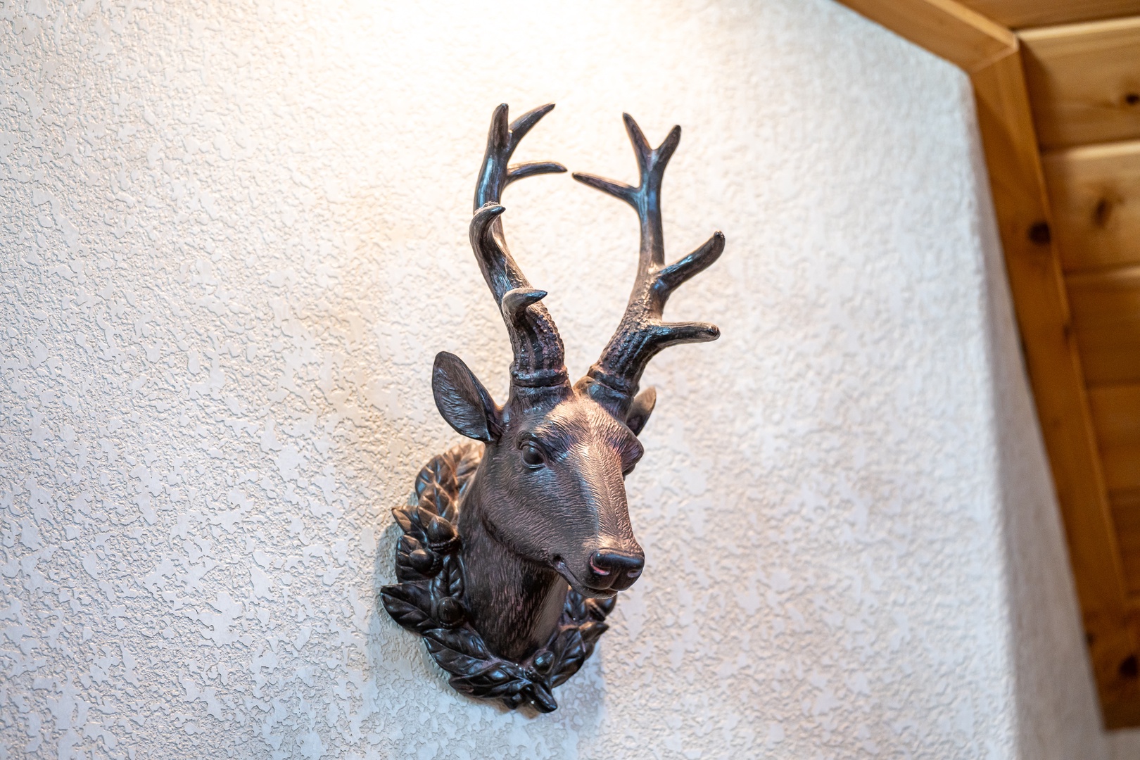 This handcrafted deer head sculpture adds rustic mountain charm to your cozy retreat, creating an authentic alpine atmosphere.