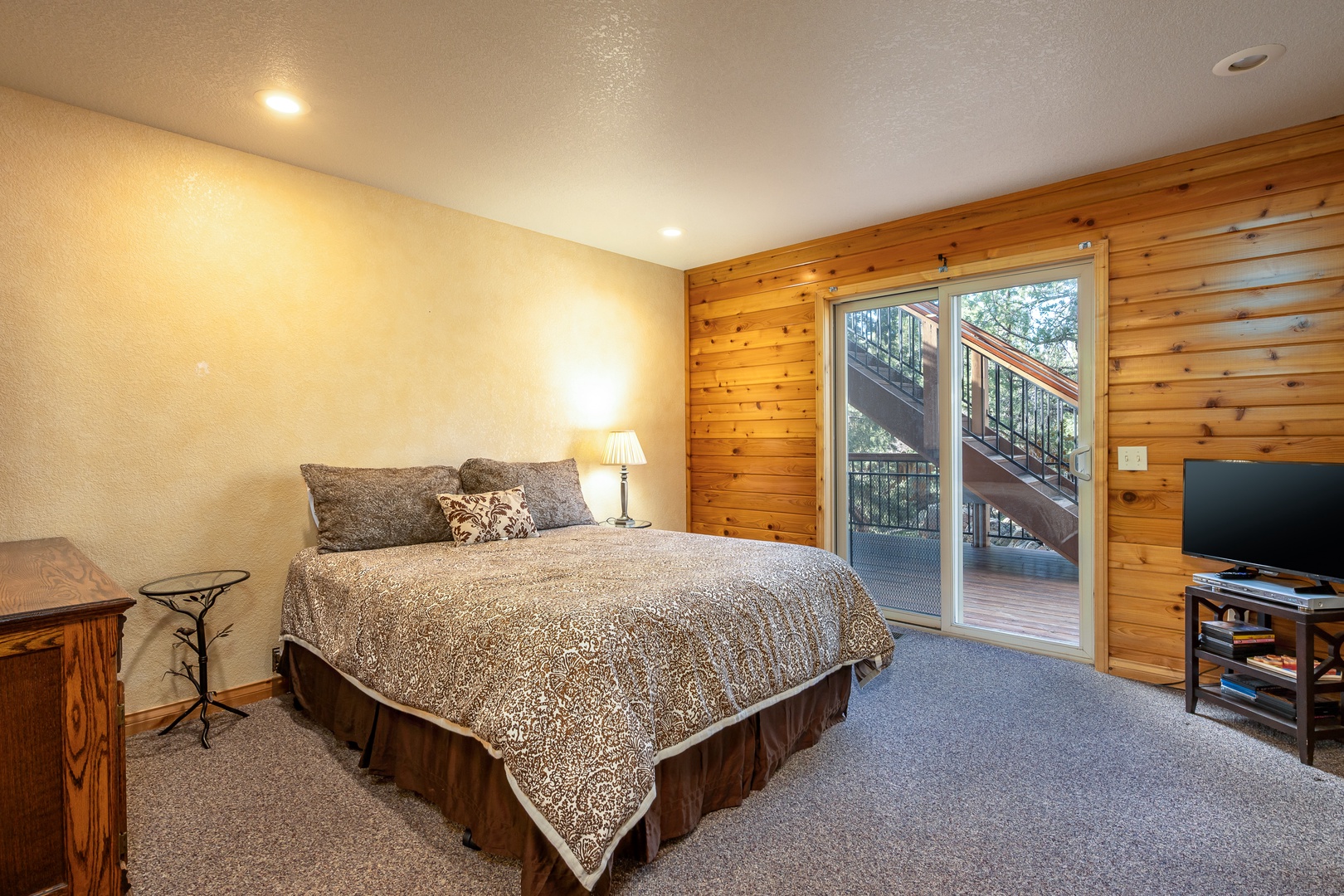 Unwind in your cozy retreat with rustic wood accents, comfortable bedding, and private deck access for morning coffee or evening relaxation.
