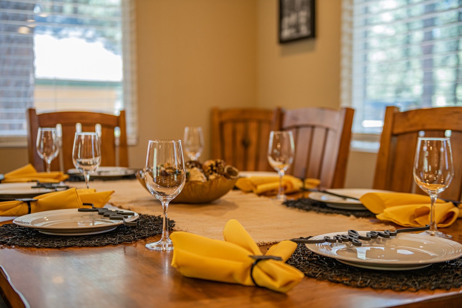 Gather around this inviting dining table, beautifully set for your group dinners. The warm ambiance and thoughtful details create the perfect space for shared meals and memorable conversations.