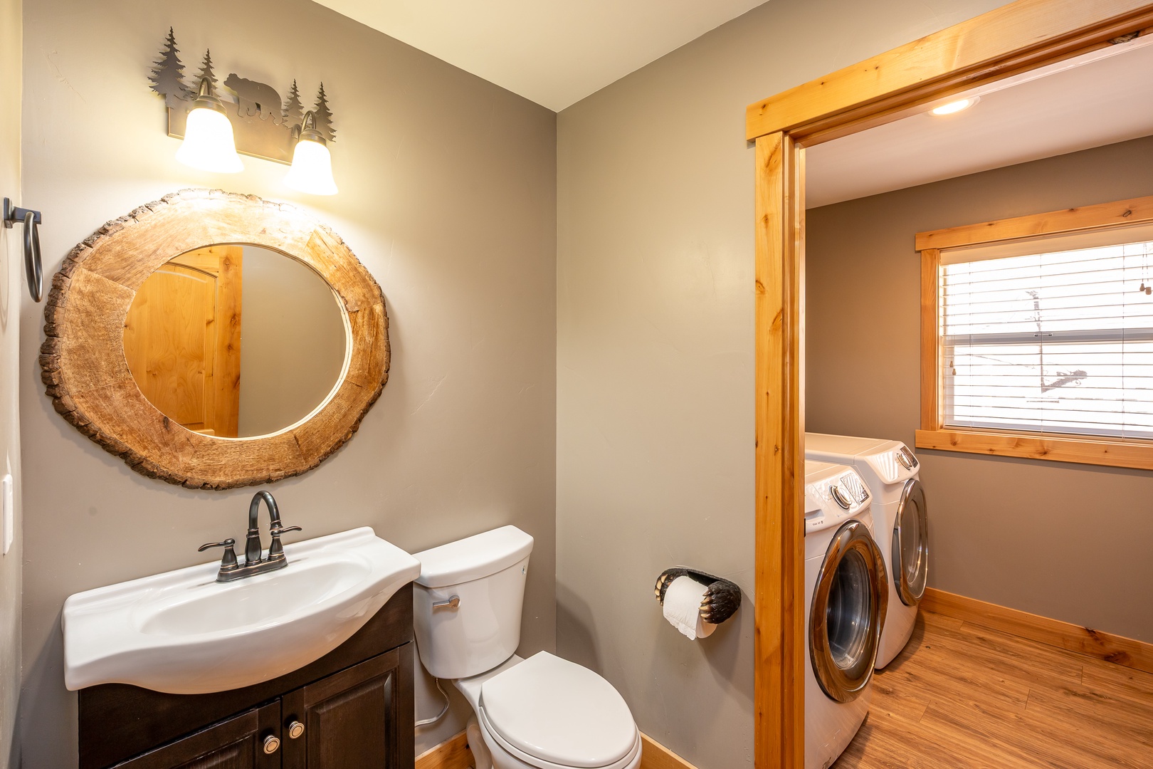 Freshen up in this powder room dusted with rustic charm. Convenient laundry access is just steps away.