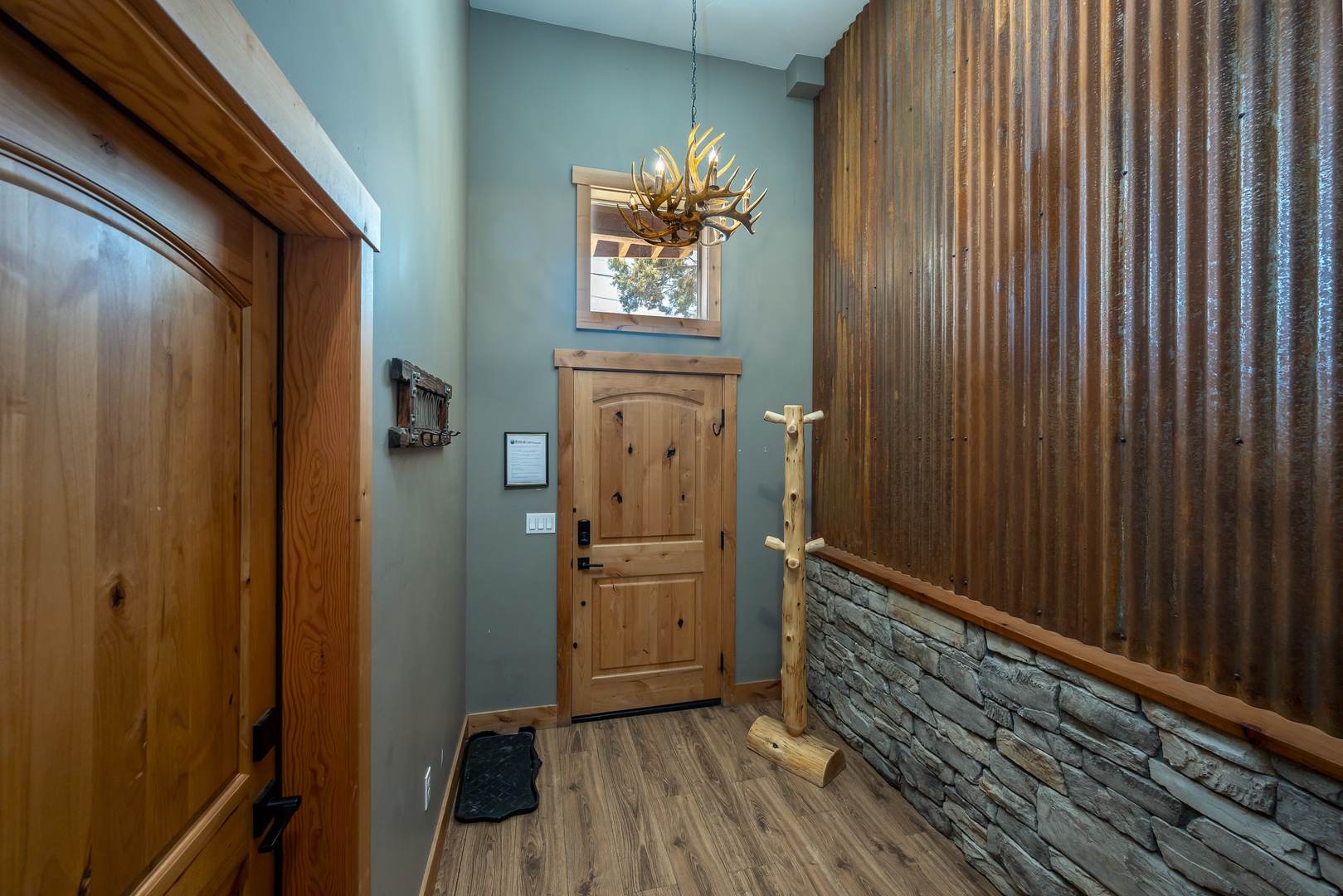 Step inside to rustic charm: soaring ceilings, warm wood tones, and a striking antler chandelier welcome you into your mountain retreat.