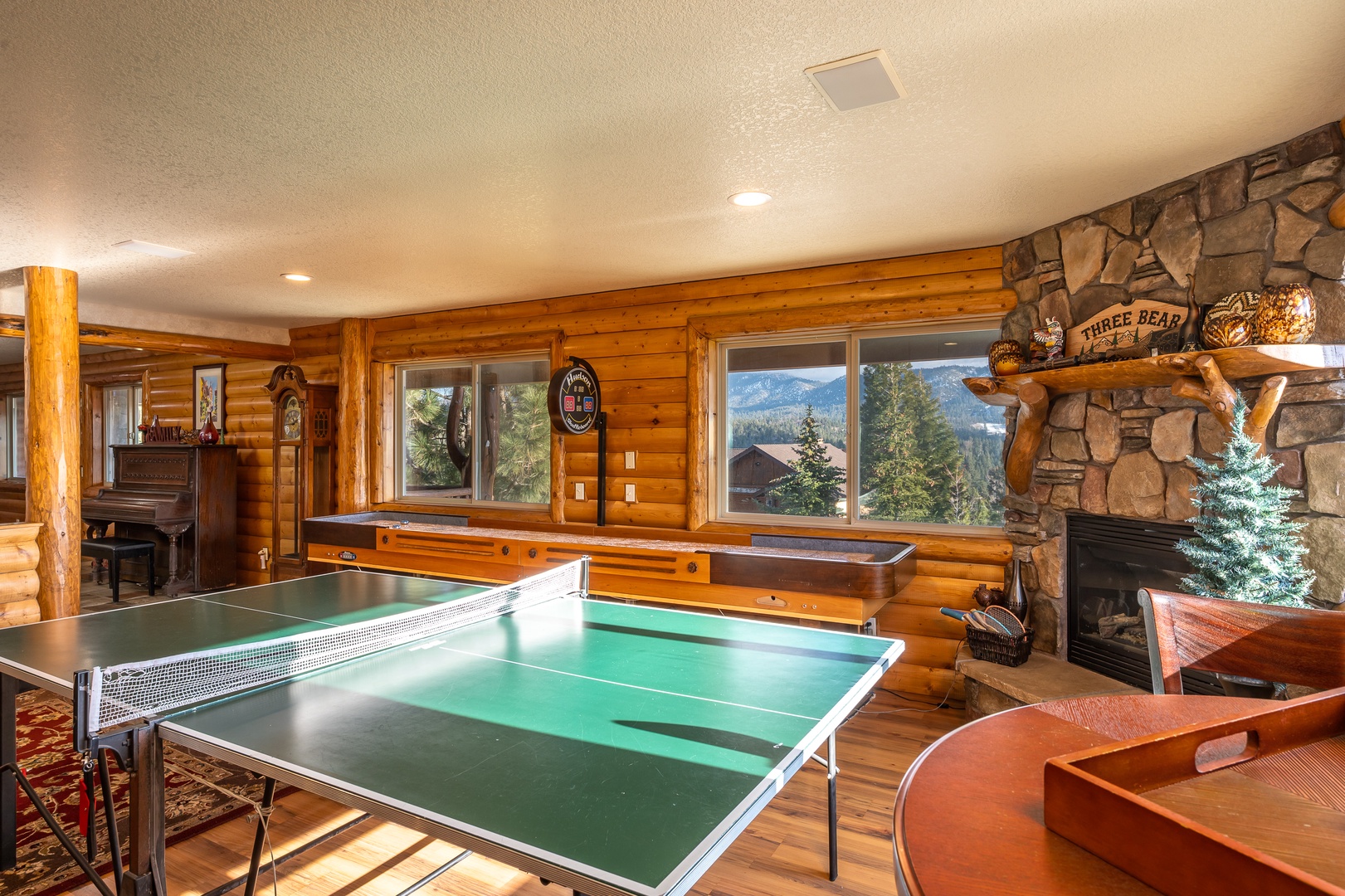 Challenge friends to ping pong while enjoying mountain views from this cozy game room with rustic charm and crackling fireplace.