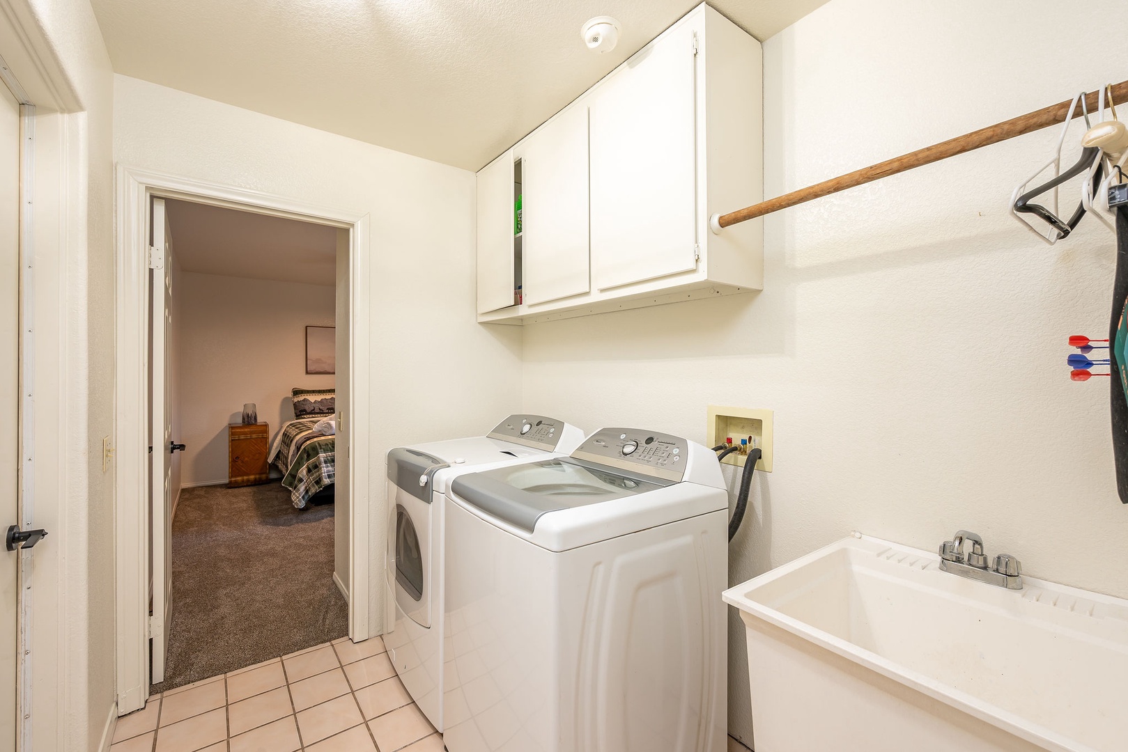 Your laundry room features a full-size washer and dryer with convenient upper storage cabinets and a utility sink for all your washing needs.