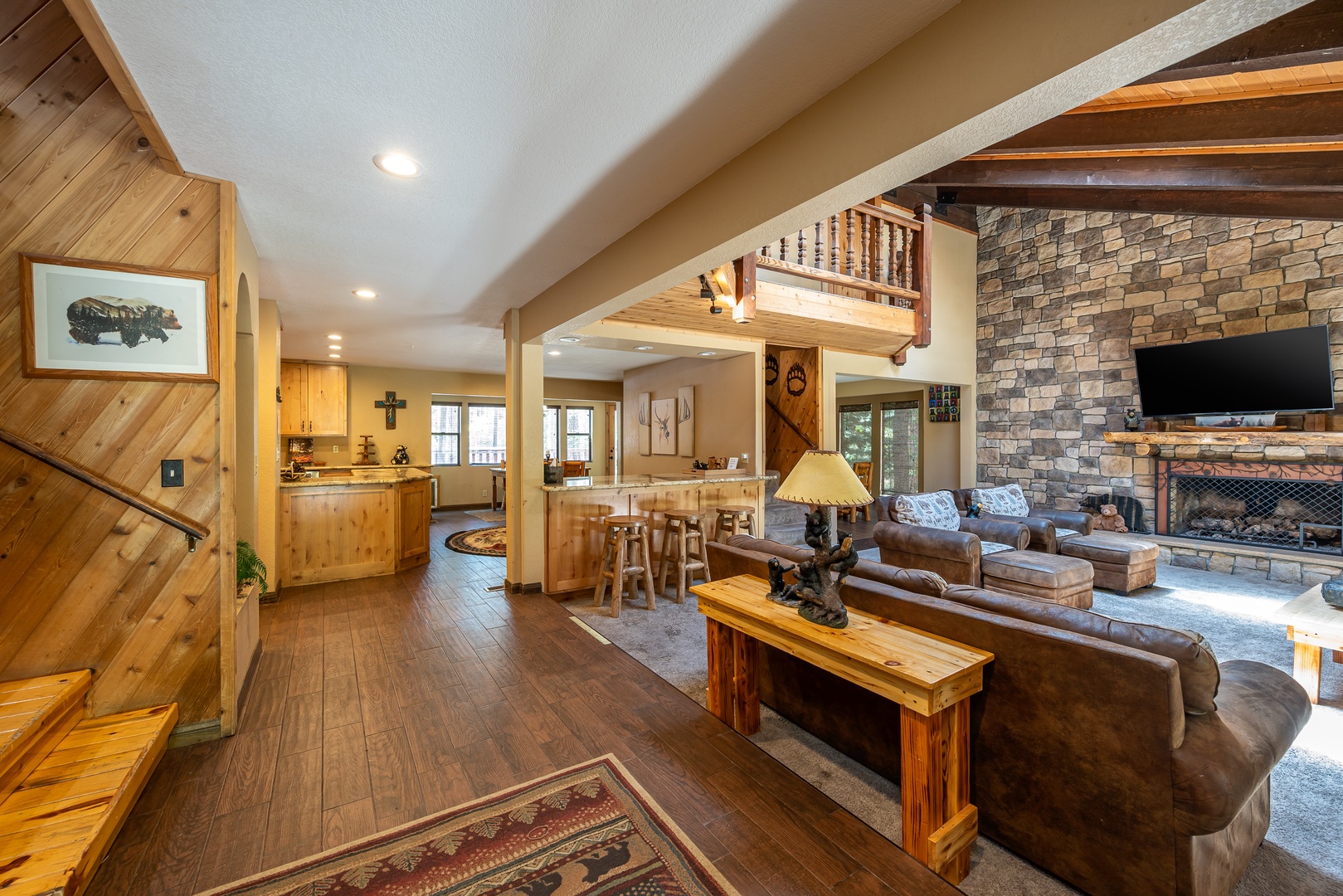 Warm wood details and a stunning stone fireplace create your mountain retreat. Spacious open layout connects living room, dining nook, and kitchen—ideal for gathering with loved ones after adventure-filled days.