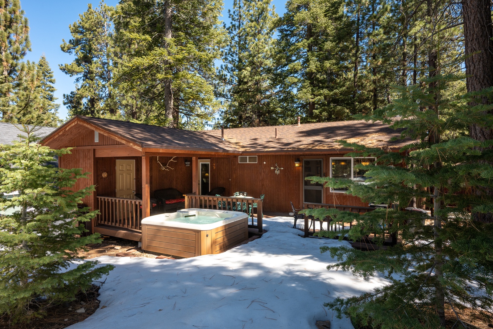 This cozy cabin nestled among towering pines offers a peaceful mountain retreat, complete with a private hot tub for soaking under the trees after days of adventure.