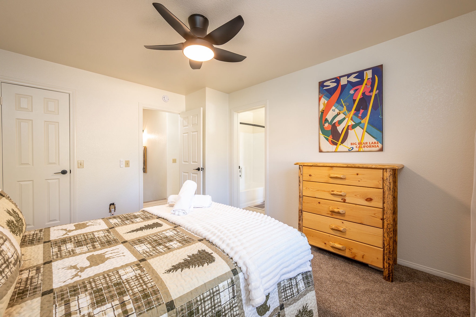 Relax in your peaceful bedroom with cozy linens with wooden furnishings