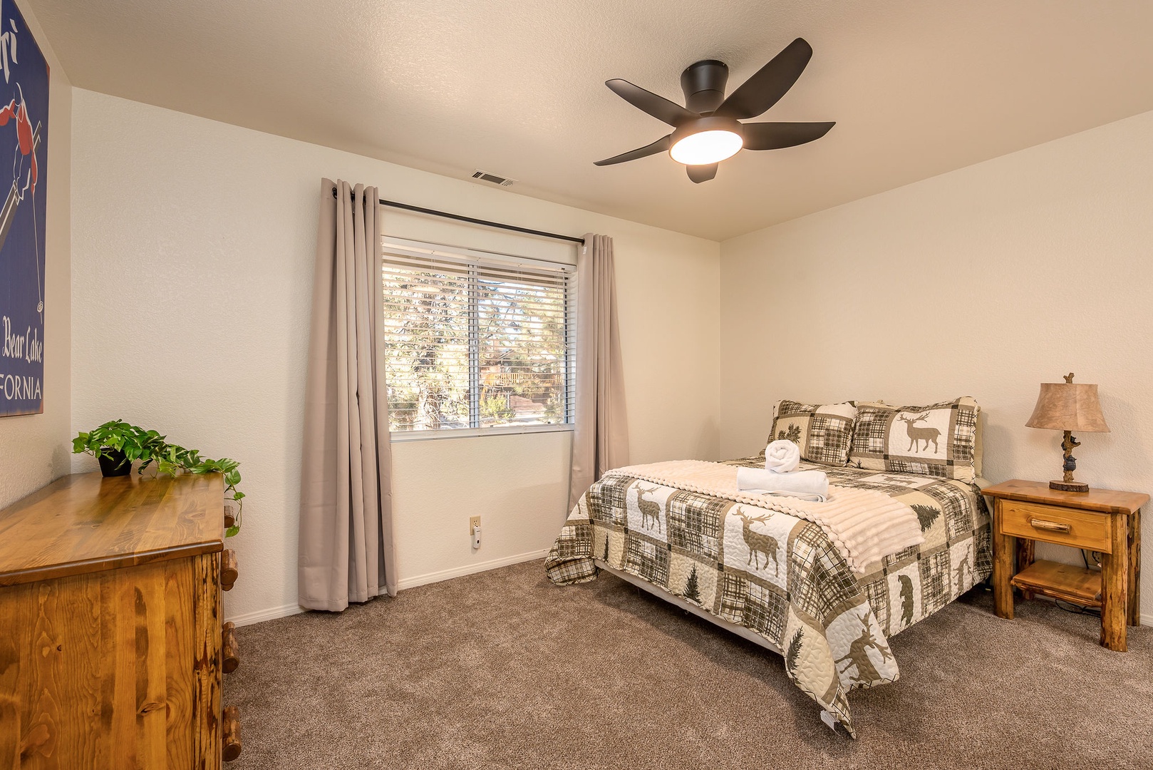 Cozy bedroom with rustic charm - your peaceful retreat! The ceiling fan keeps the room comfortable year round.