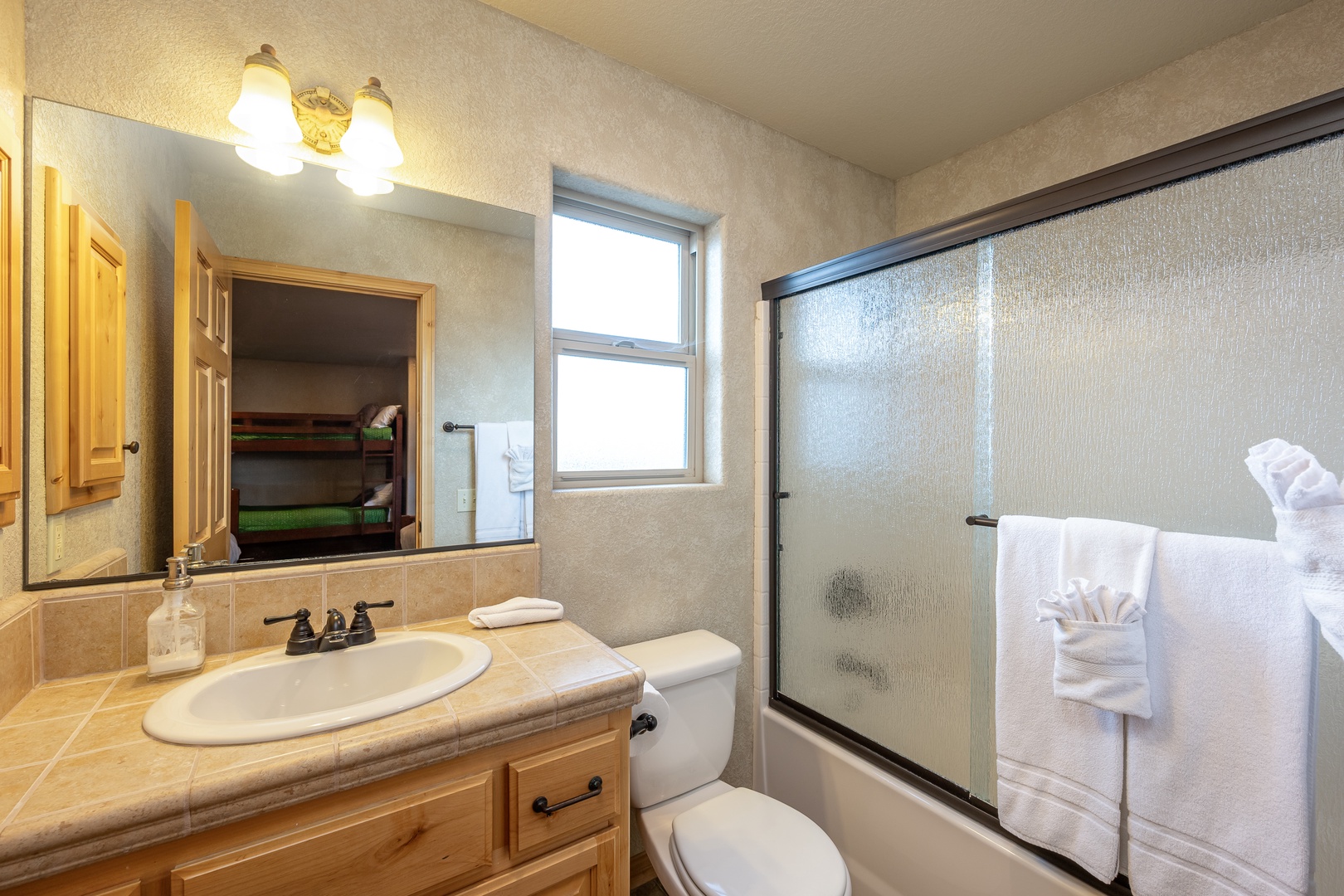 Freshen up in your private bathroom with fluffy towels, warm lighting, and a spacious shower to start your day perfectly.