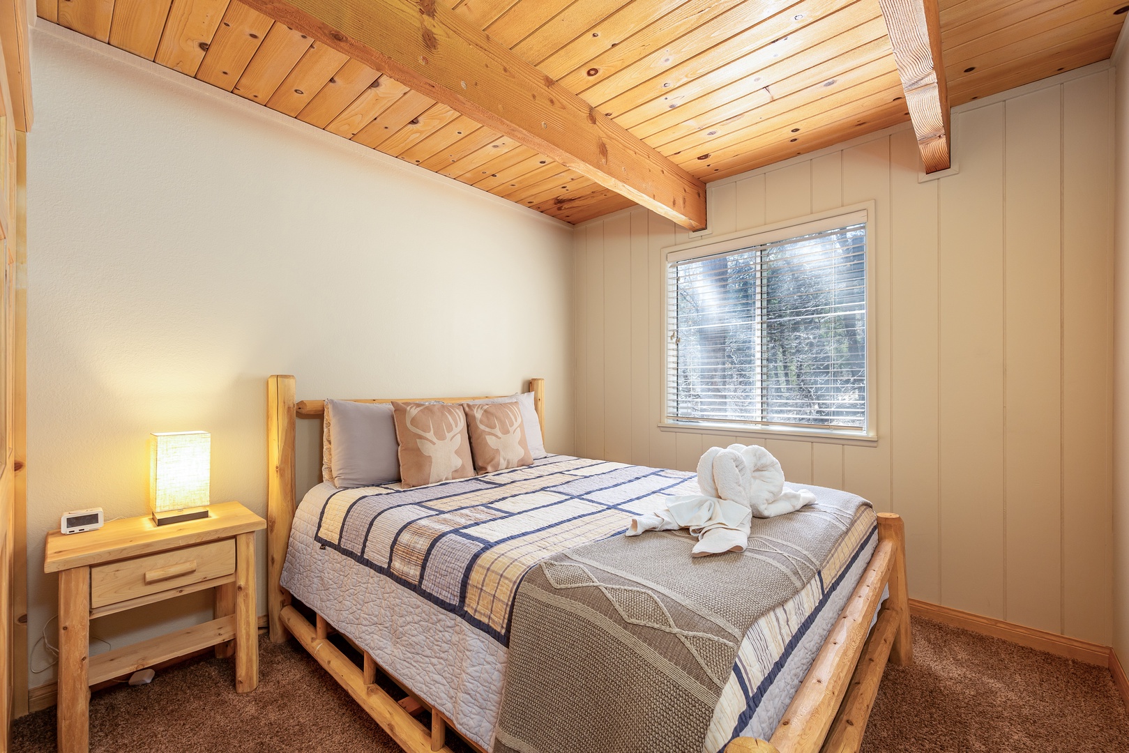 Drift off to sleep beneath beautiful exposed wood beams in your cozy bedroom, where rustic charm meets modern comfort.