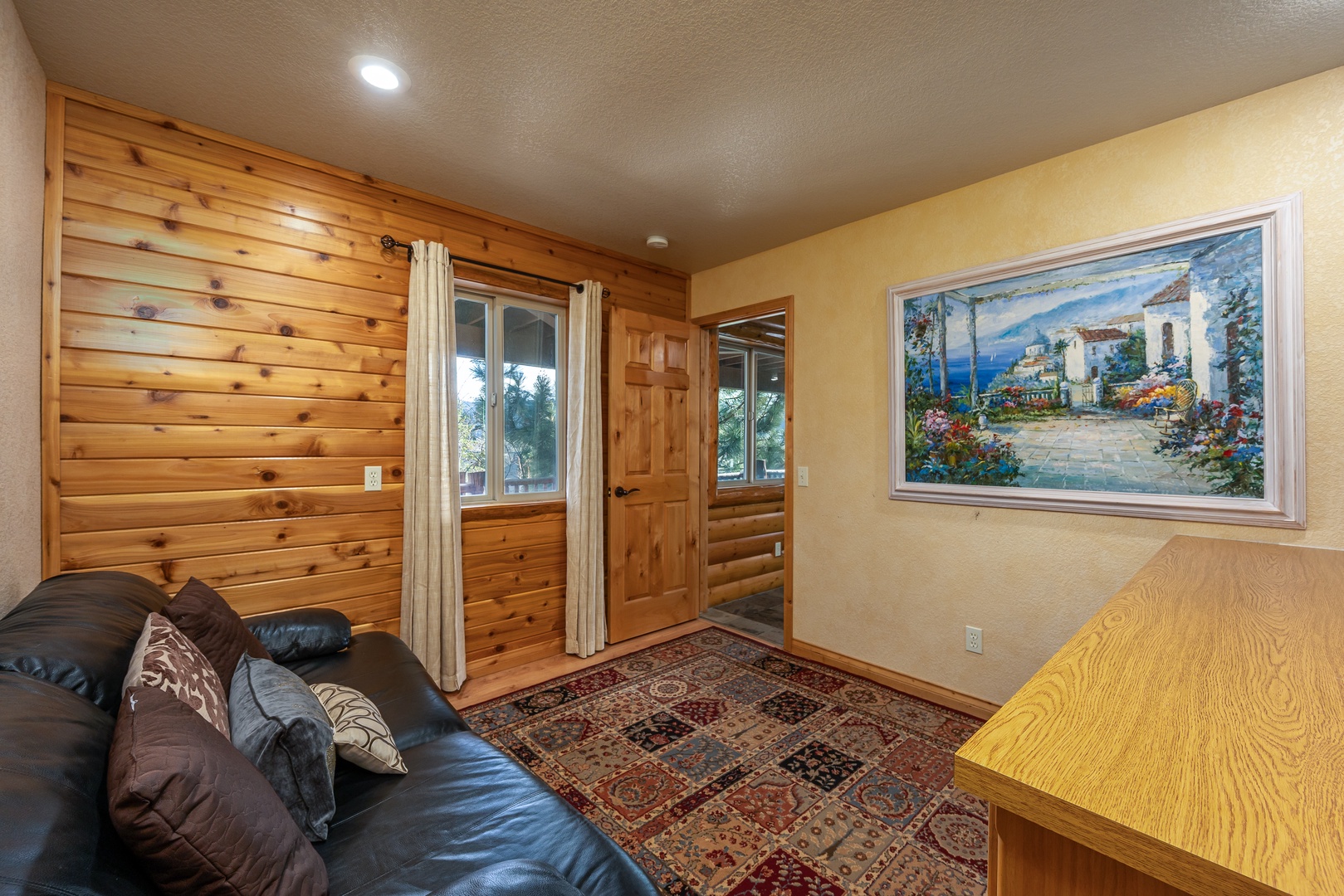 Sink into the plush leather couch and admire the coastal artwork while warm wood walls create your perfect mountain retreat.