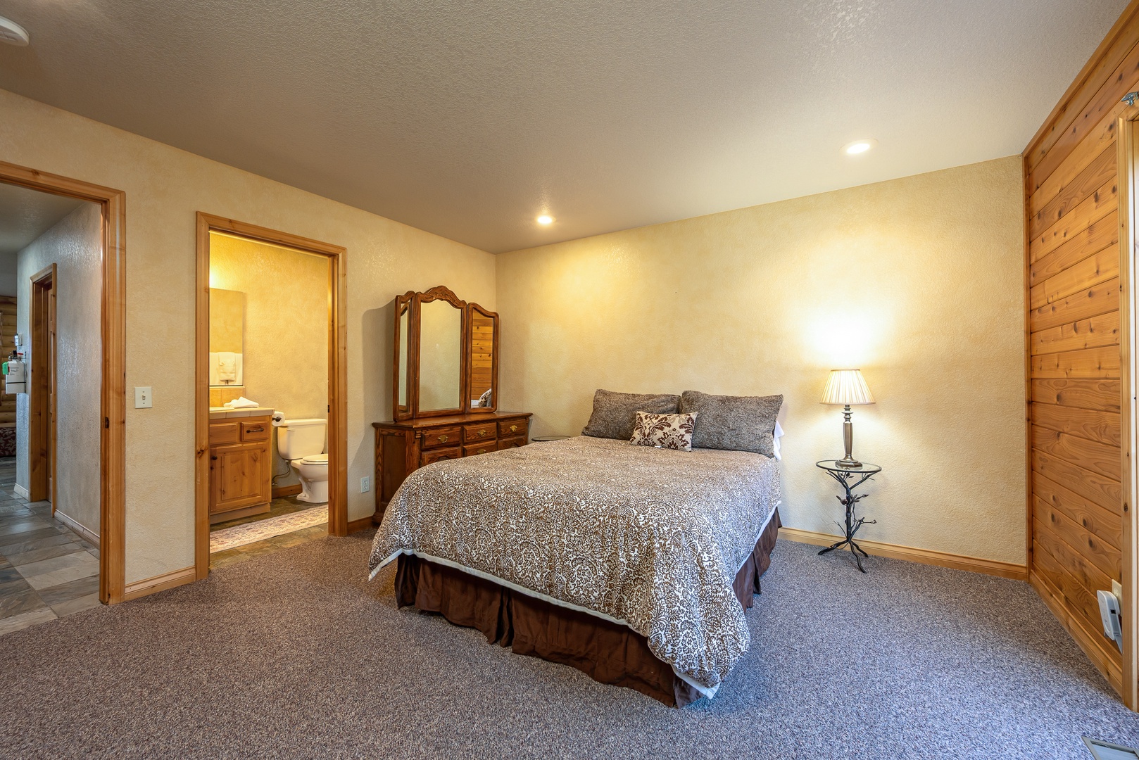 Unwind in your spacious bedroom with comfortable bedding and warm wood accents that create the perfect retreat for restful nights.