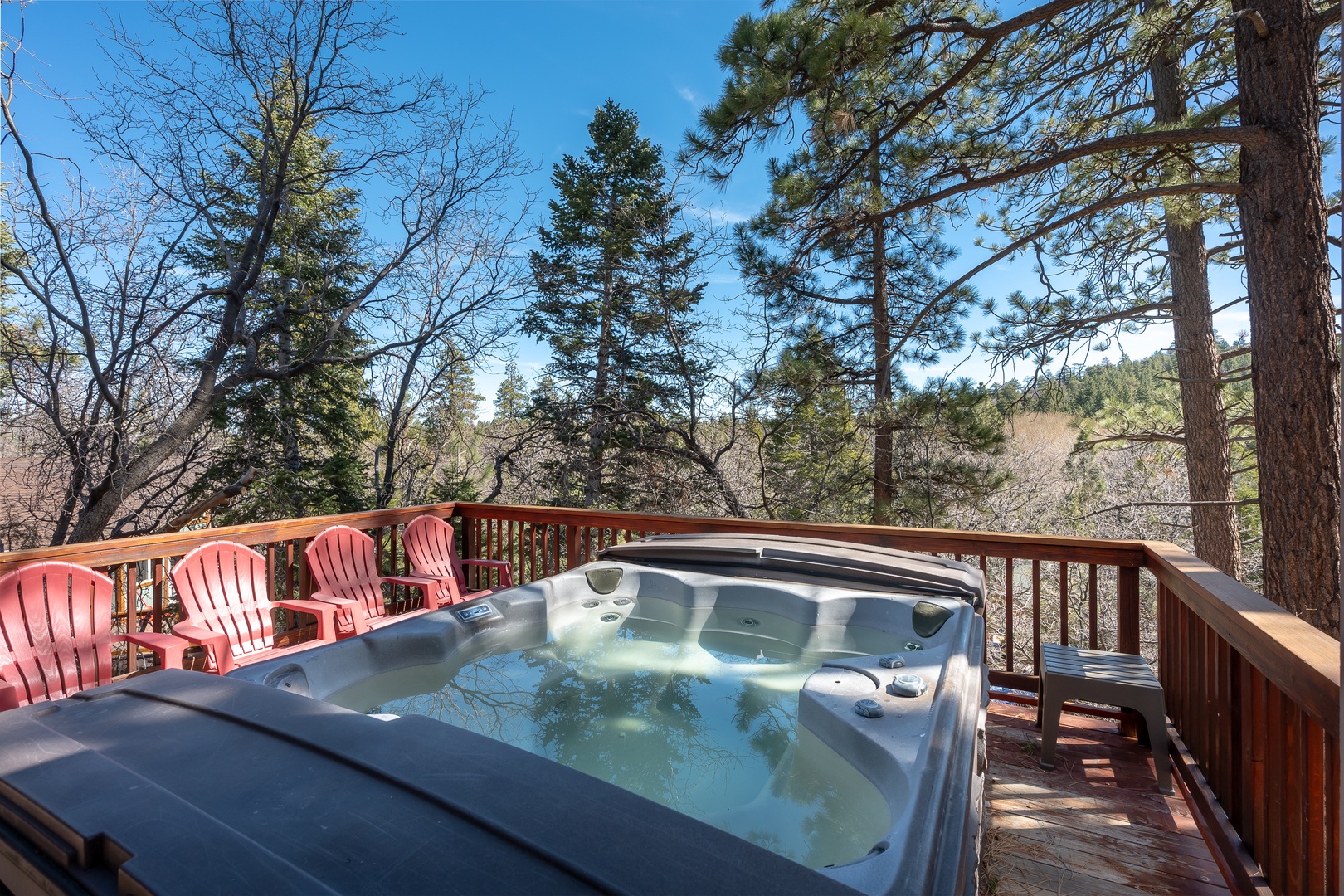 Soak in your private hot tub while taking in peaceful forest views from this tranquil deck retreat.