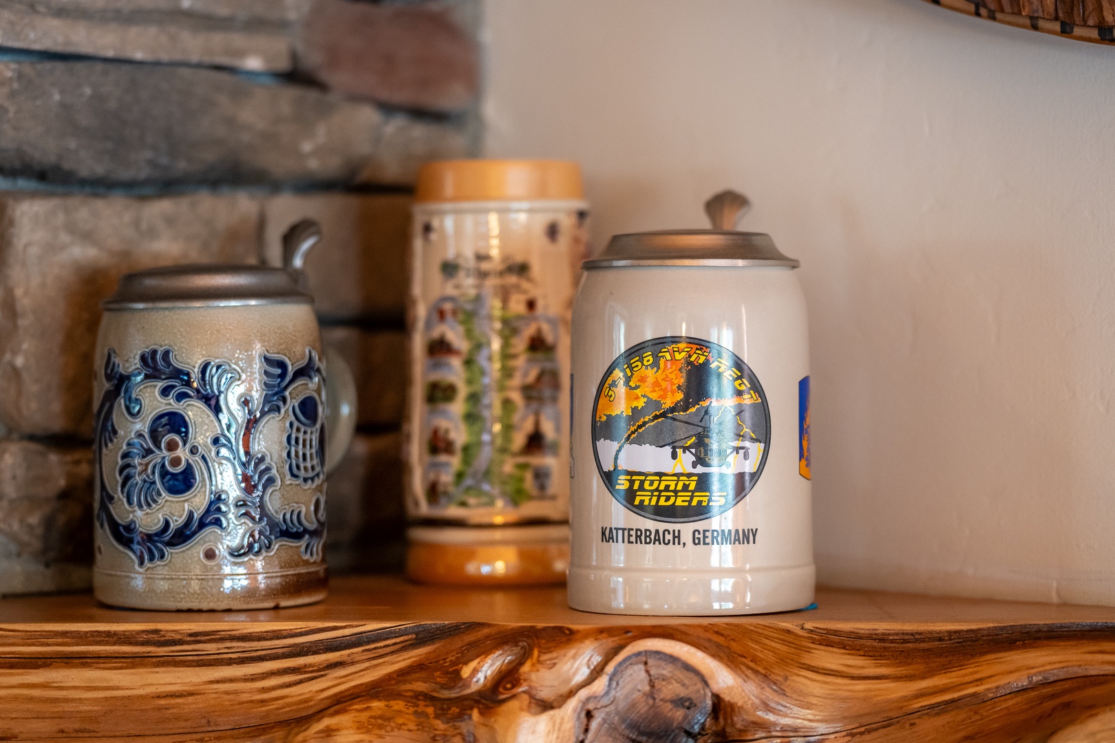 Your cozy retreat features authentic German beer steins displayed on rustic wooden shelves, adding cultural charm to your mountain getaway.