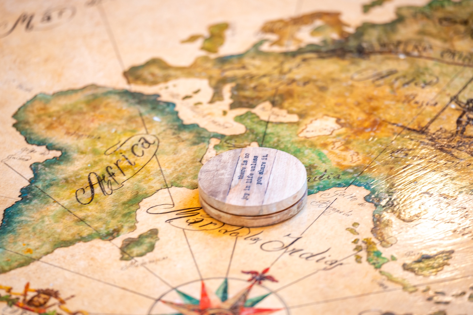 Discover your next adventure with this beautiful vintage-style world map, complete with a classic compass - perfect for planning dream getaways from your cozy retreat.