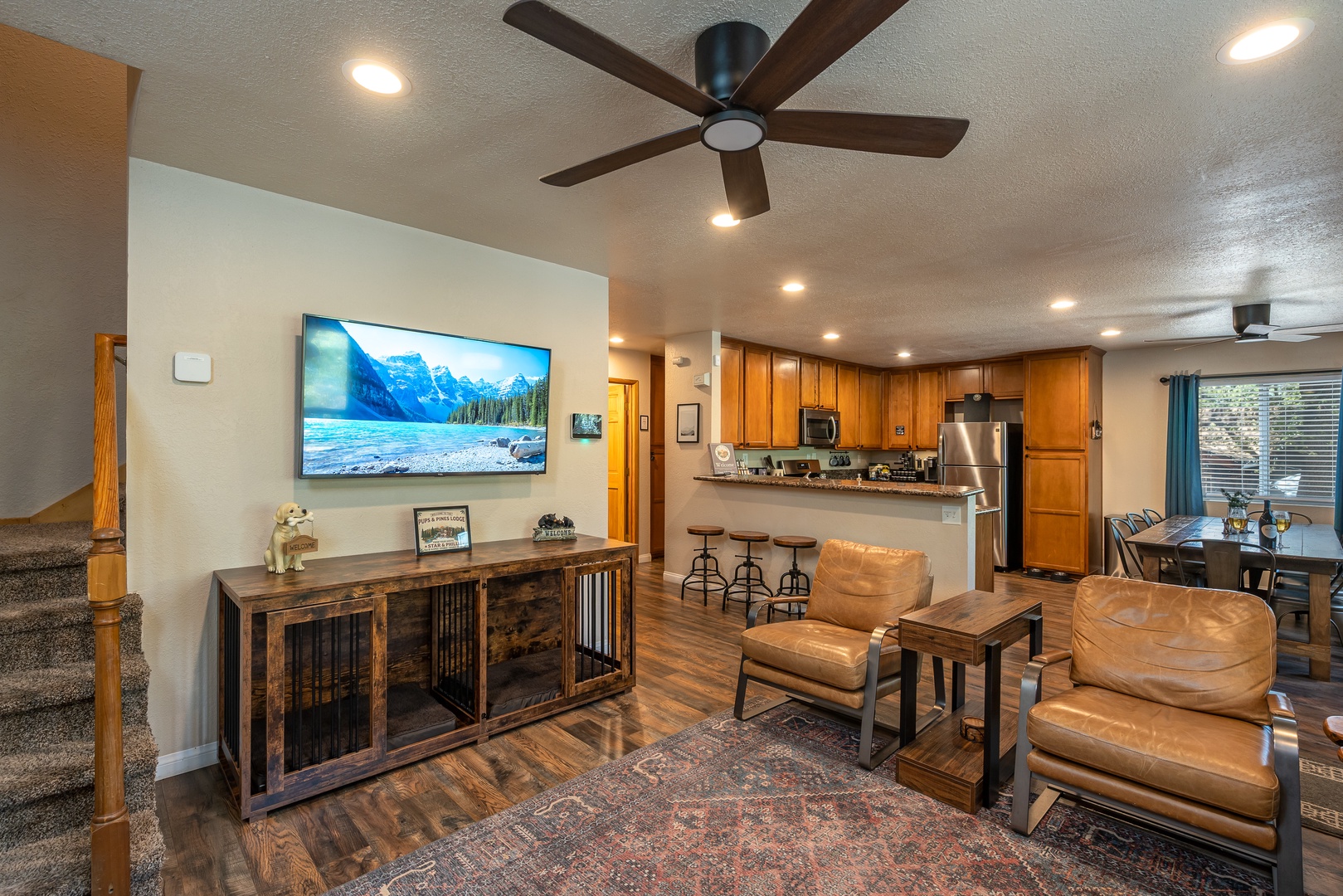 Step into your inviting open-concept retreat, where warm wood tones and modern comfort blend seamlessly. Relax in plush leather seating or gather in the fully-equipped kitchen—your perfect mountain getaway awaits.