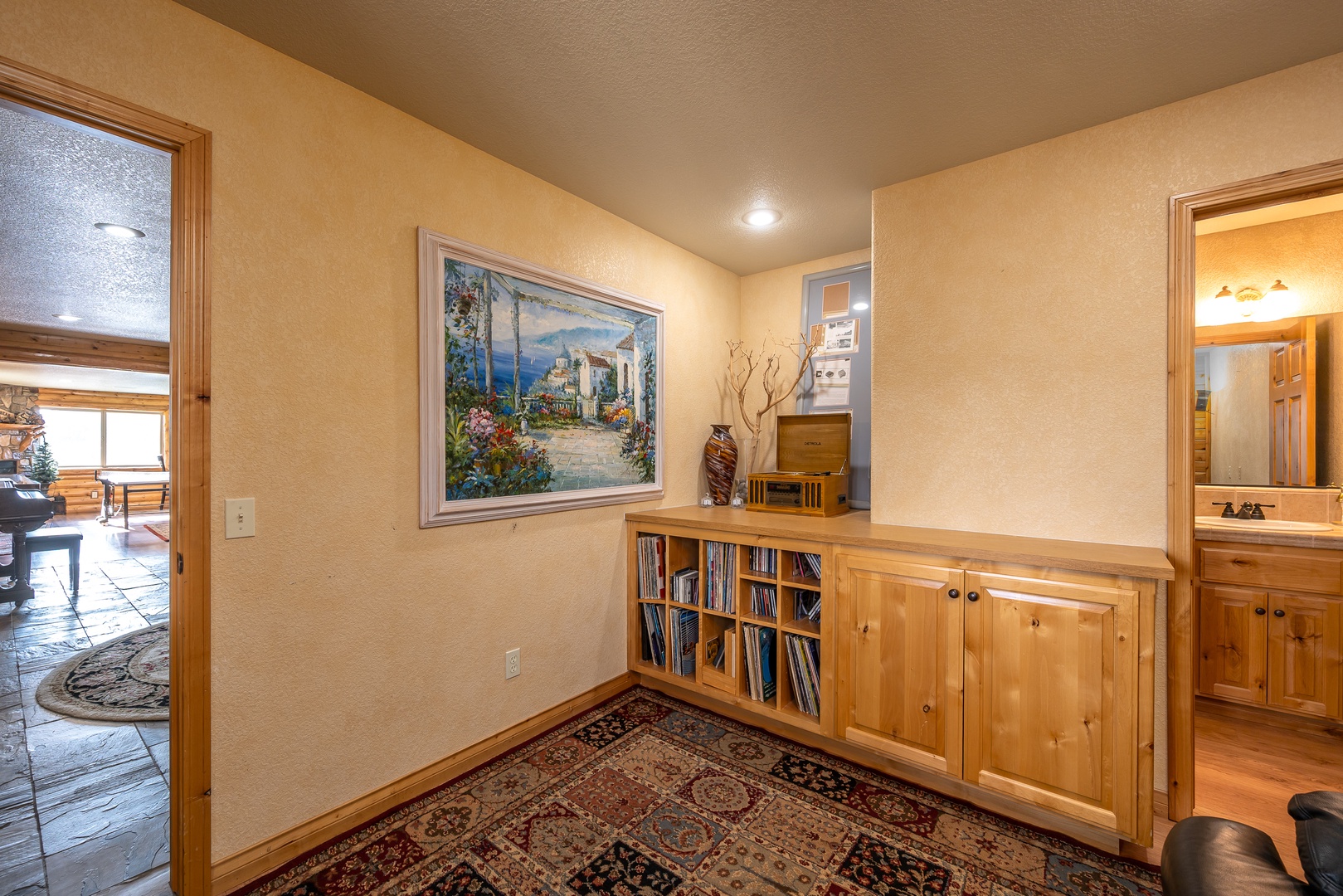 Your personal reading nook and music room awaits with record player and vinyl library, built-in bookshelves and warm wood tones creating the perfect spot to unwind.
