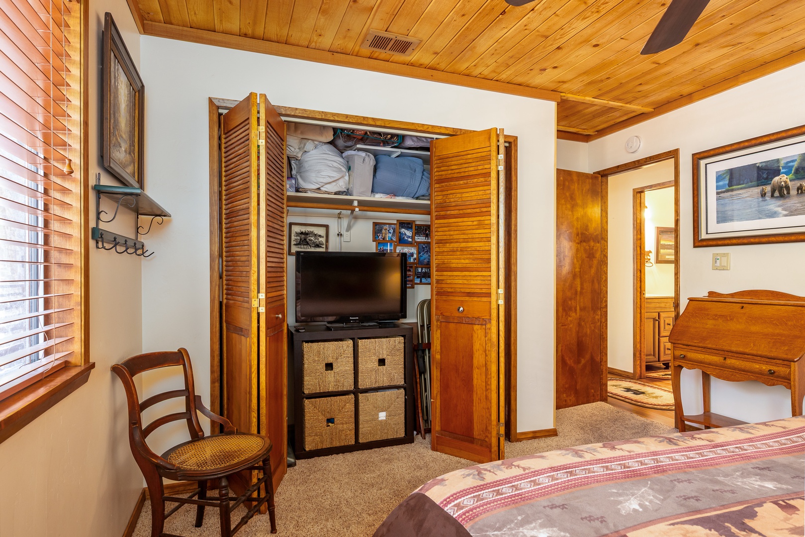 Cozy up in your bedroom with vaulted wood ceilings, a spacious wardrobe for your belongings, and a flat-screen TV ready for relaxing evenings.