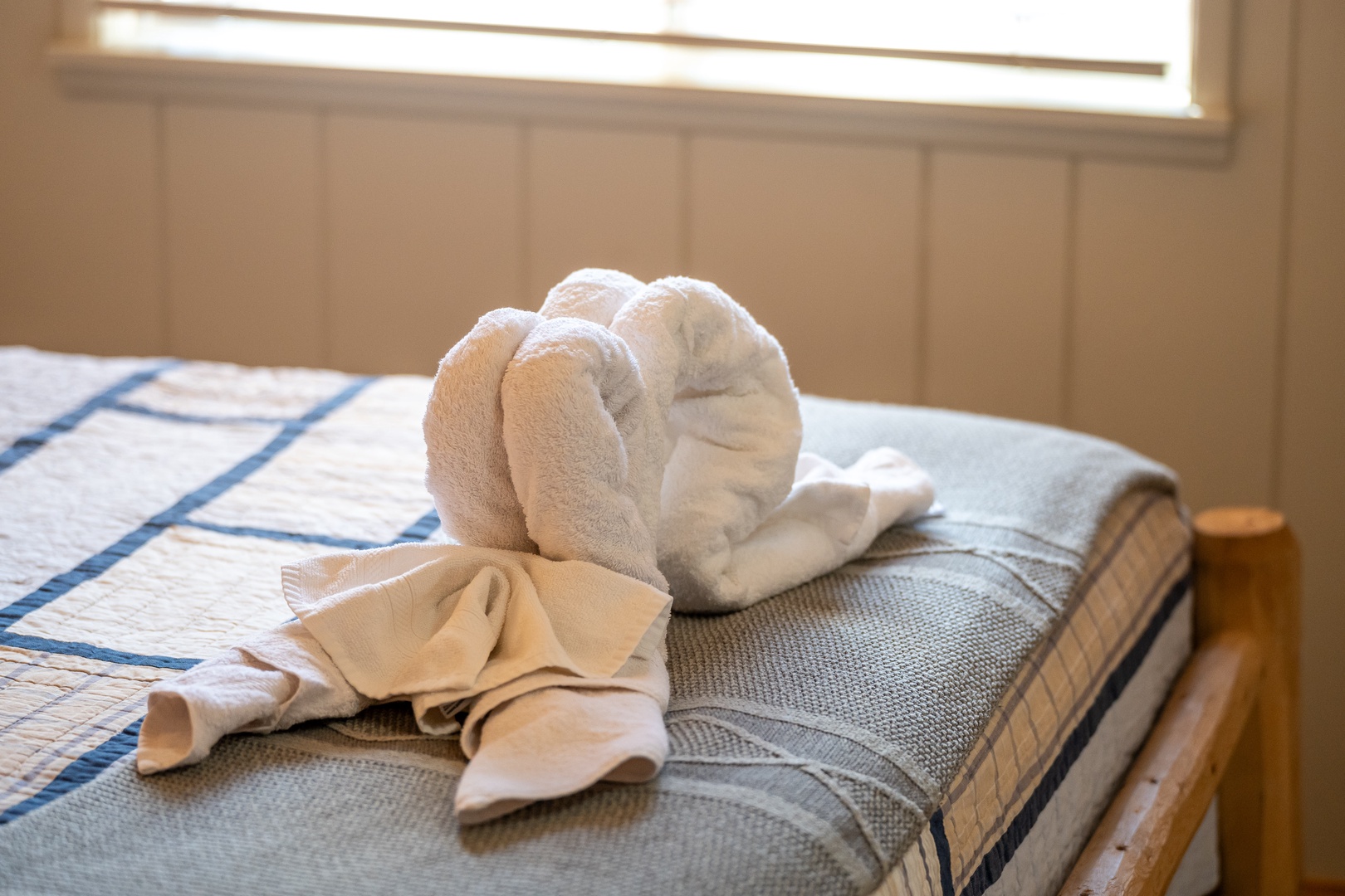 Fresh towels await your arrival, thoughtfully arranged on crisp linens with natural light streaming through your window.