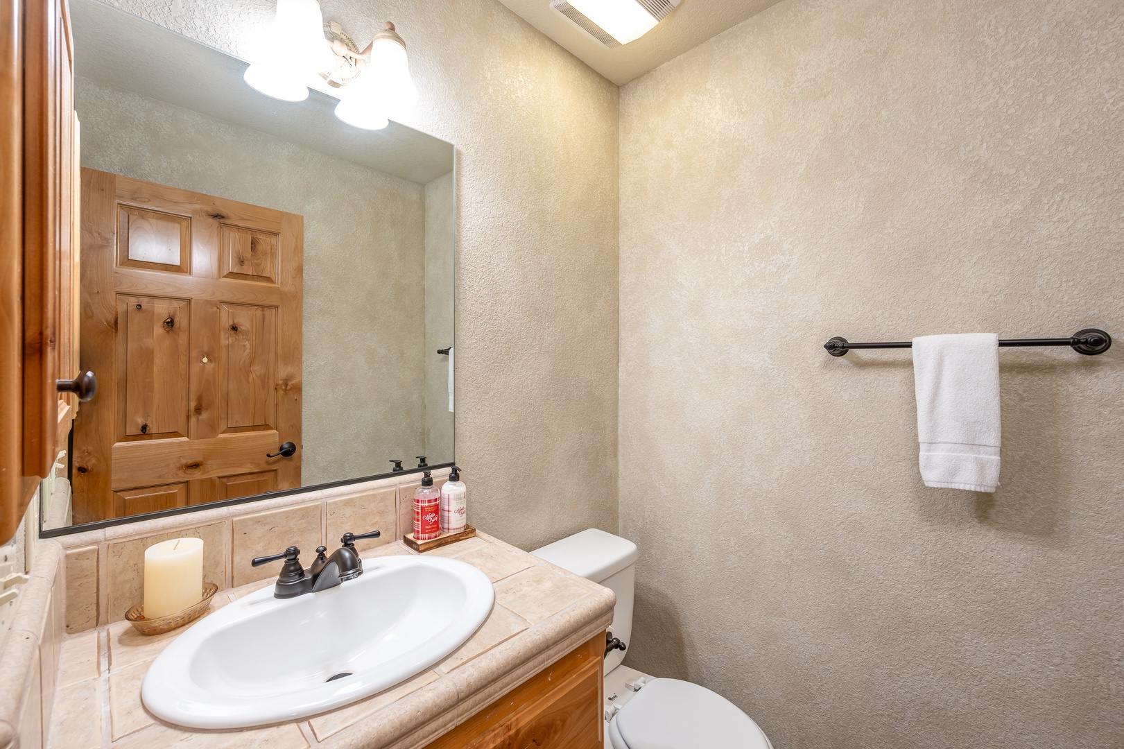 Your private bathroom features warm wood accents and thoughtful touches like fresh towels and a skylight for natural brightness.