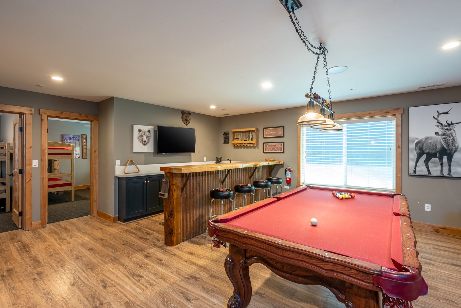Challenge your friends to a game at your stylish pool table, then relax at the rustic bar while enjoying your favorite shows on the flat-screen TV.