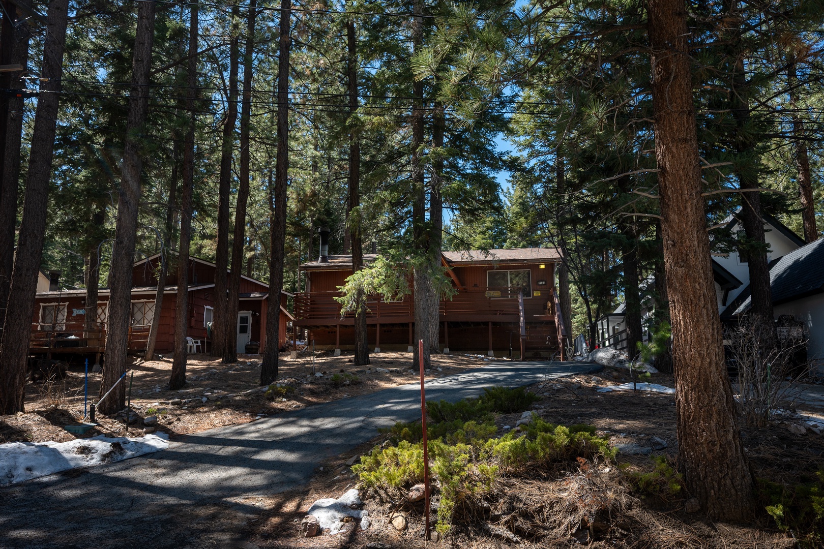 Nestled among towering pines, this rustic mountain cabin offers a peaceful retreat with natural beauty, ample parking, and easy driveway access to your wooded escape.