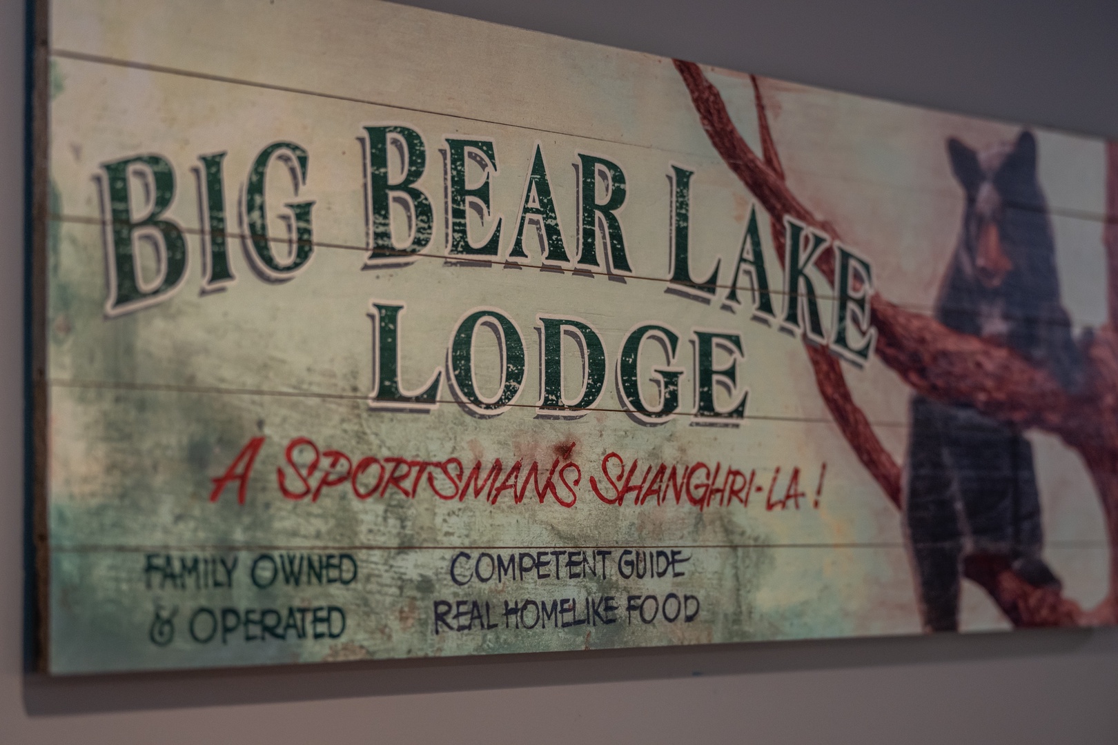 A vintage-style sign for Big Bear Lake Lodge captures the rugged charm of this mountain retreat, promising a sportsman's paradise with family hospitality.