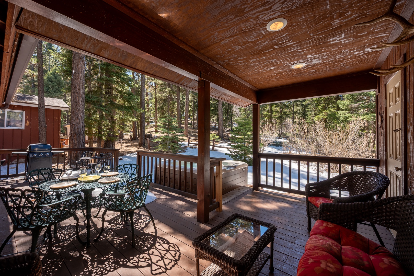 Unwind on your private covered deck surrounded by towering pines, where mountain air and cozy seating create the perfect retreat.