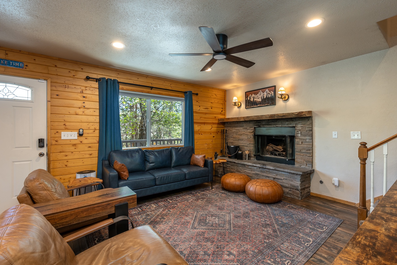 Unwind in this welcoming living space where warm wood walls, plush leather seating, and a cozy stone fireplace create the perfect mountain retreat. Gather around with your favorite people and enjoy the natural light streaming through the windows.