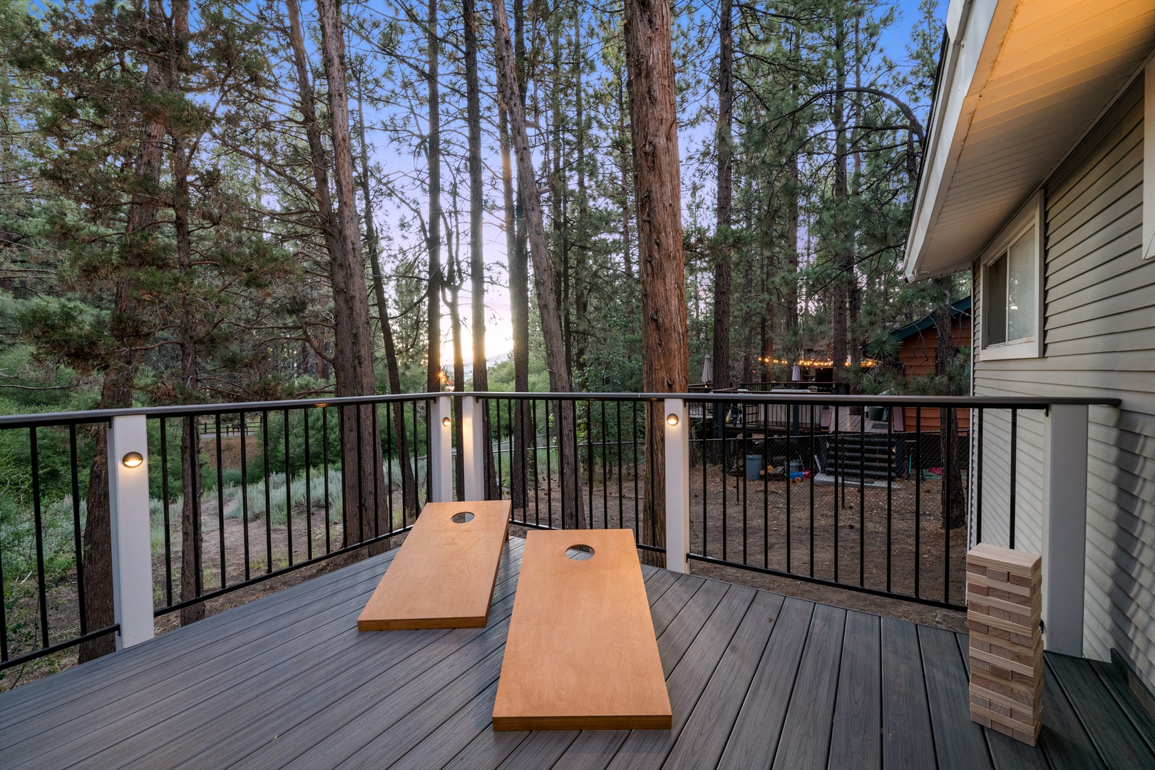 Roll up your sleeves as you challenge friends to cornhole surrounded by towering pines under the golden evening light—pure mountain serenity.