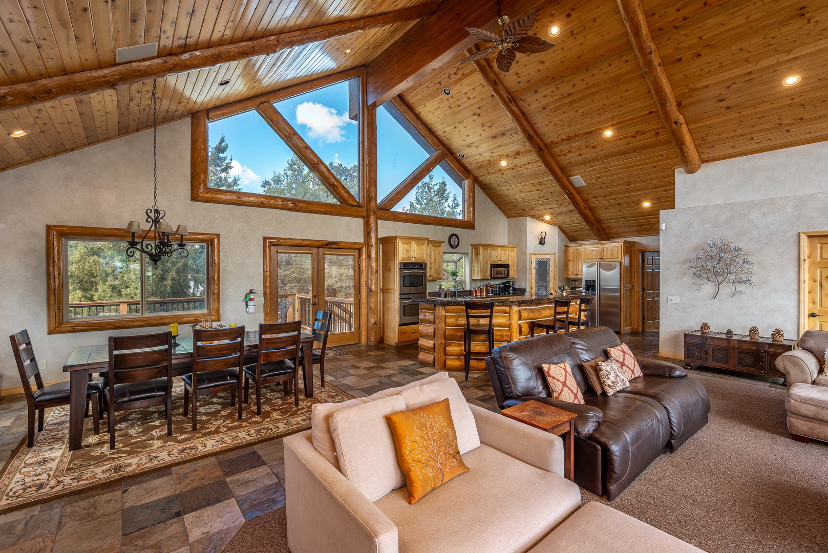 Relax in your expansive great room where soaring wood ceilings and panoramic windows create a perfect mountain retreat atmosphere.