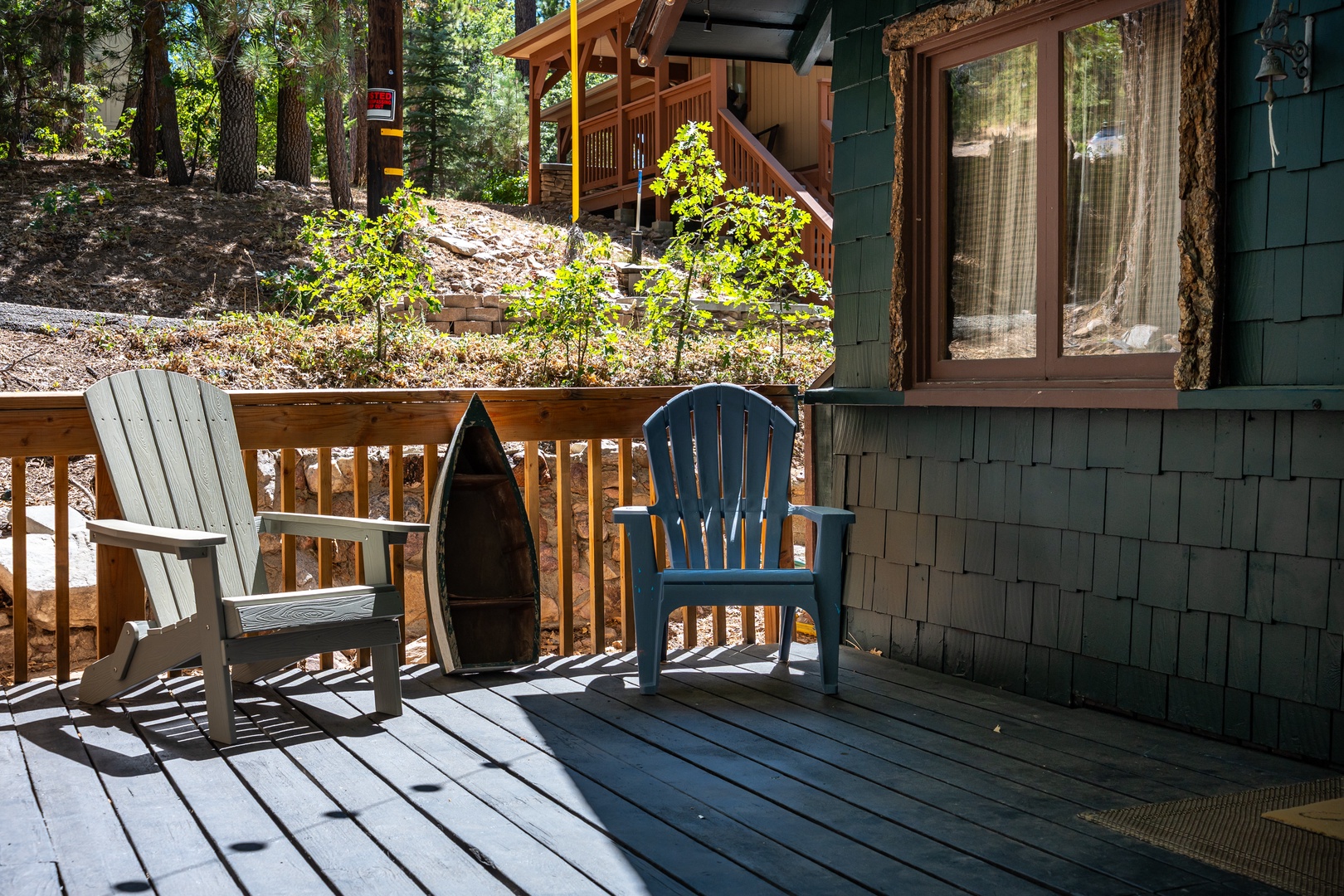 Your private deck overlooks towering pines and neighboring cabins, offering the perfect spot to unwind with morning coffee or evening conversation in the fresh mountain air.