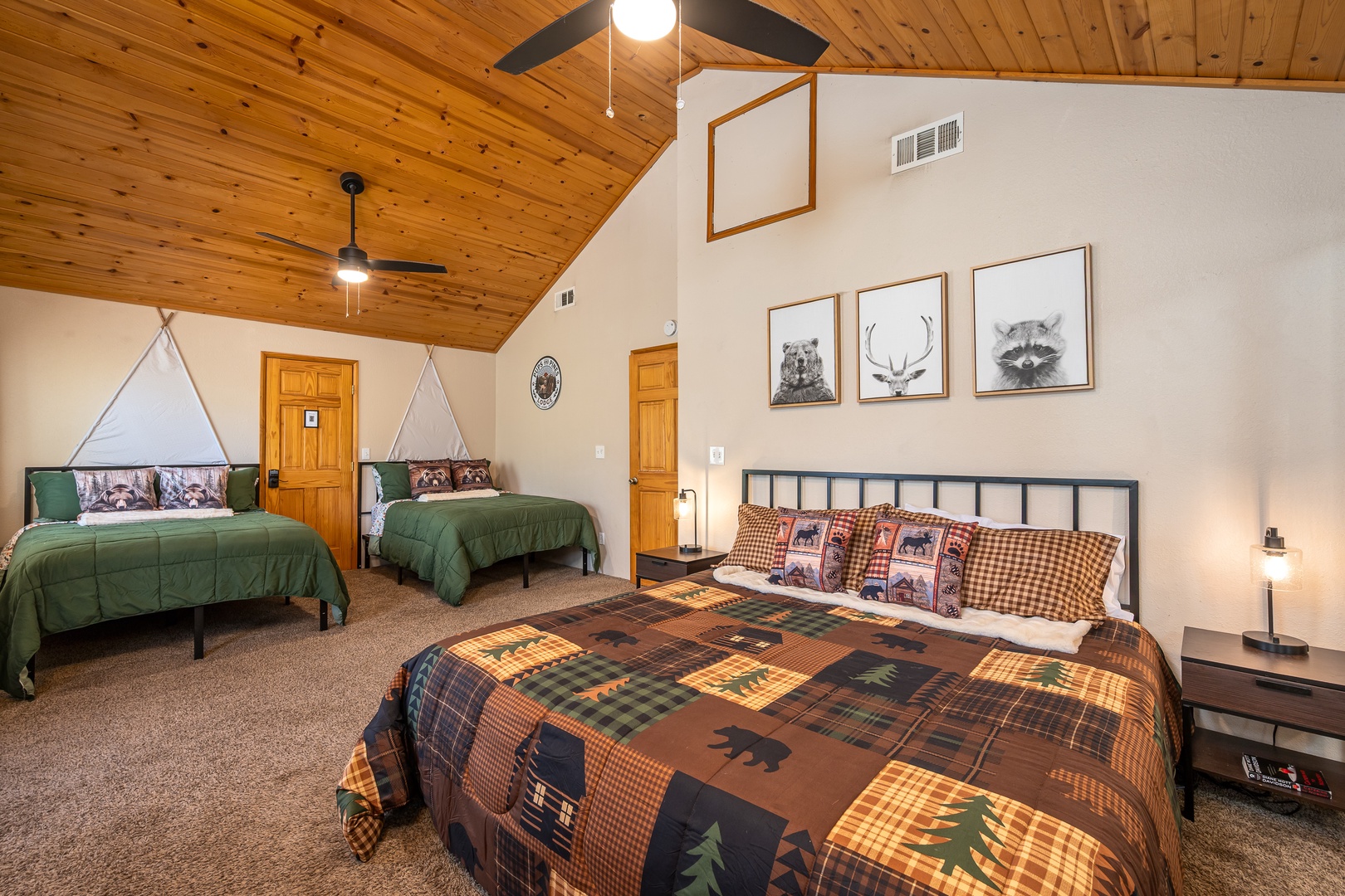 Sink into the plush quilted bed beneath wood-paneled ceilings, where rustic charm meets modern comfort with thoughtful touches throughout your inviting retreat.
