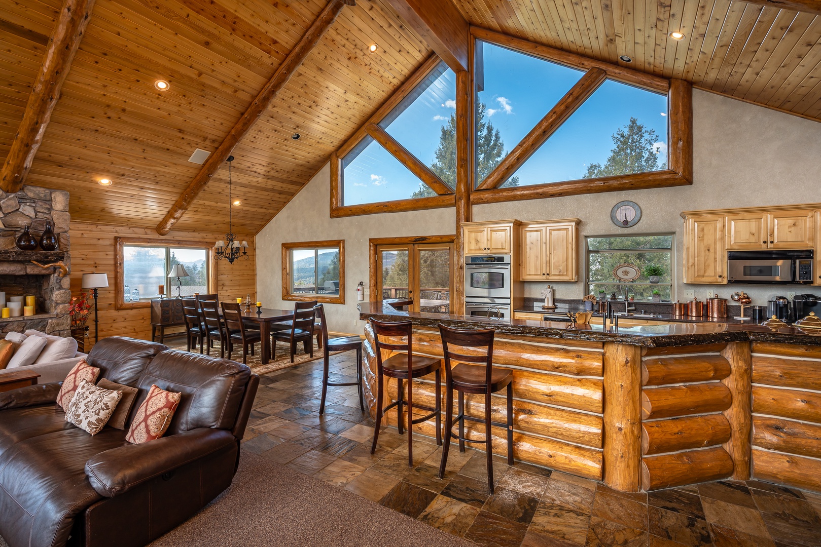 Your rustic mountain retreat features soaring ceilings, stone fireplace, and an open kitchen perfect for gathering with loved ones.
