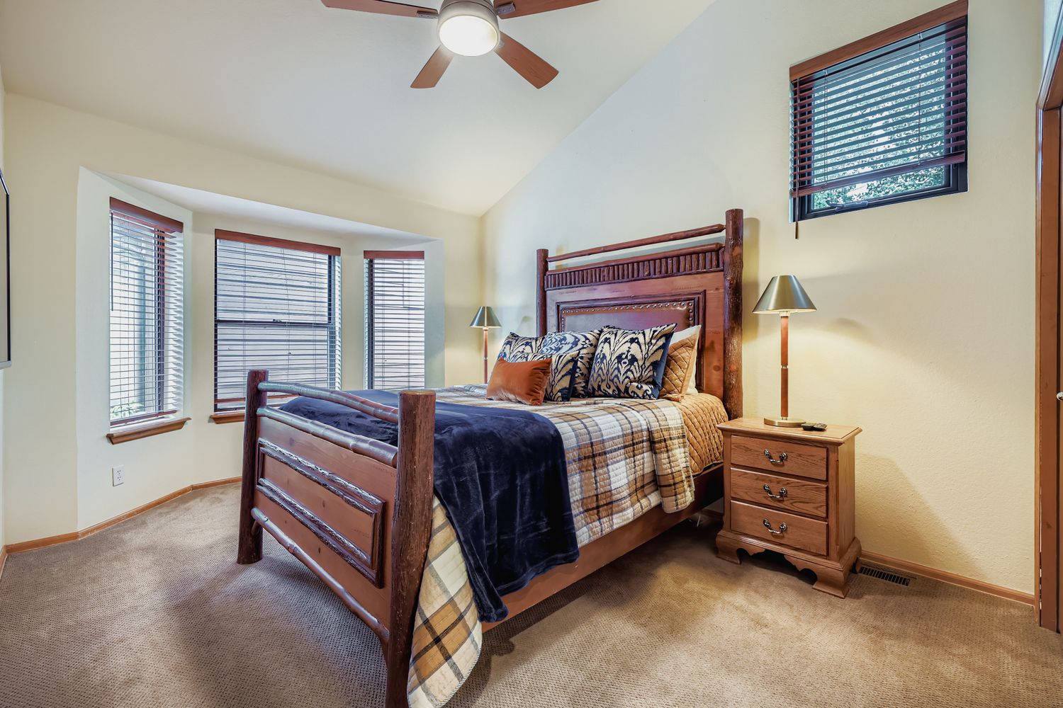 Drift off peacefully in your cozy bedroom with rustic wooden furnishings, soft bedding, and warm natural light streaming through the windows.