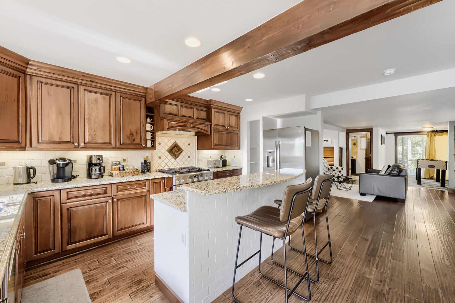 Gather around the spacious kitchen island with granite counters, custom cabinetry, and modern appliances—everything you need to cook memorable meals together in your home away from home.