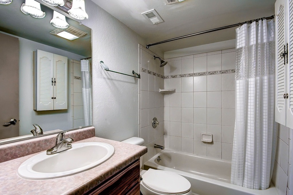 Refresh in your private bathroom with all essentials—spacious vanity, tub-shower combo, and thoughtful storage for a comfortable stay.