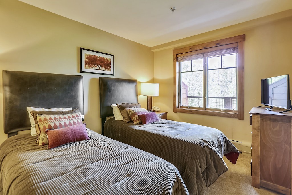 Cozy twin beds with rich textures and mountain views create your perfect retreat for restful nights and peaceful mornings.