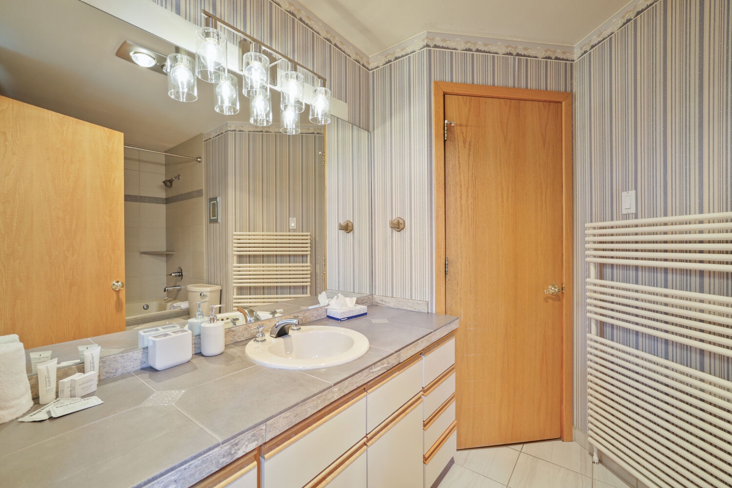 Your private bathroom offers plenty of counter space, soft lighting, and a refreshing tub-shower combo—perfect for unwinding after a day of adventure.
