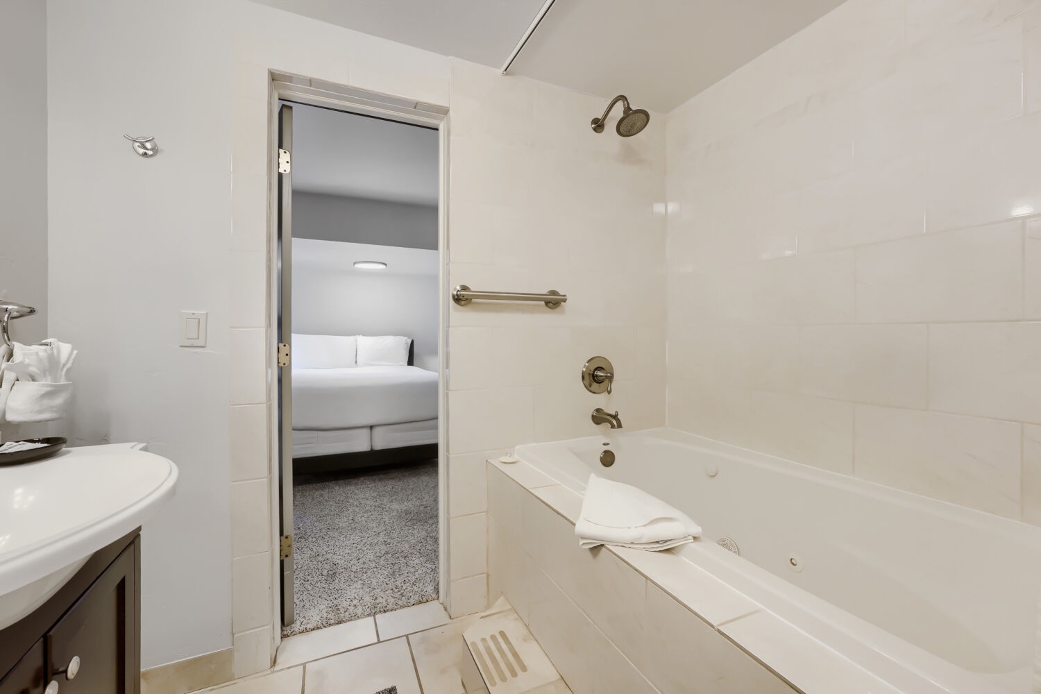 Your spacious bathroom features a full tub and shower combo, plush towels, and direct access to the comfortable bedroom—perfect for relaxing after a day of exploring.