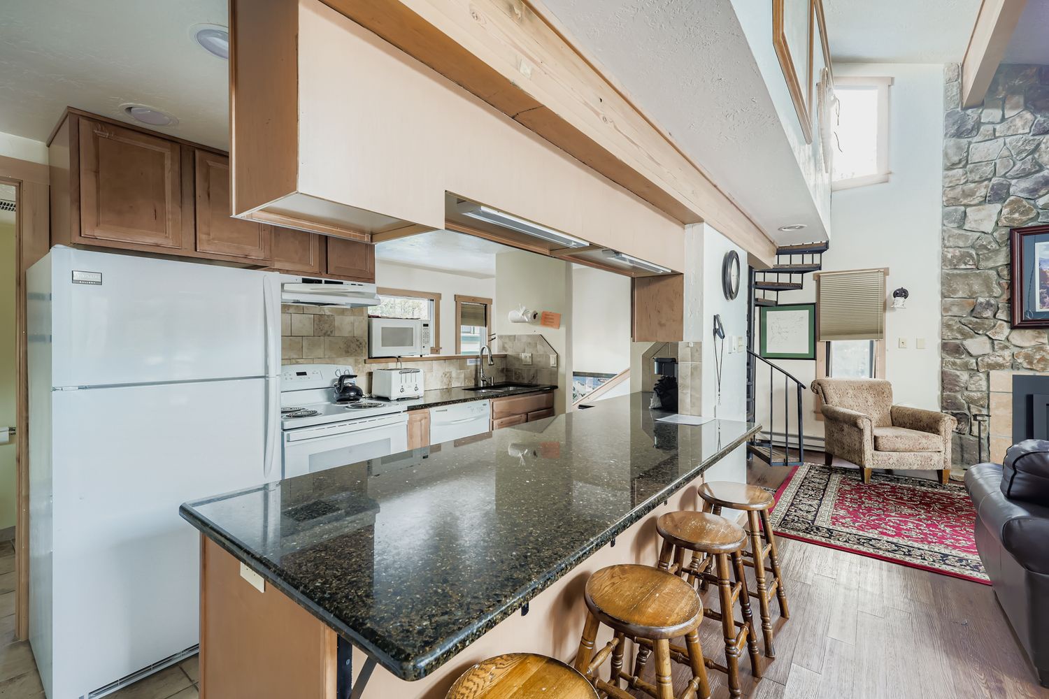 Your fully equipped kitchen features granite counters and breakfast bar where you can prepare meals while enjoying the open loft ambiance.