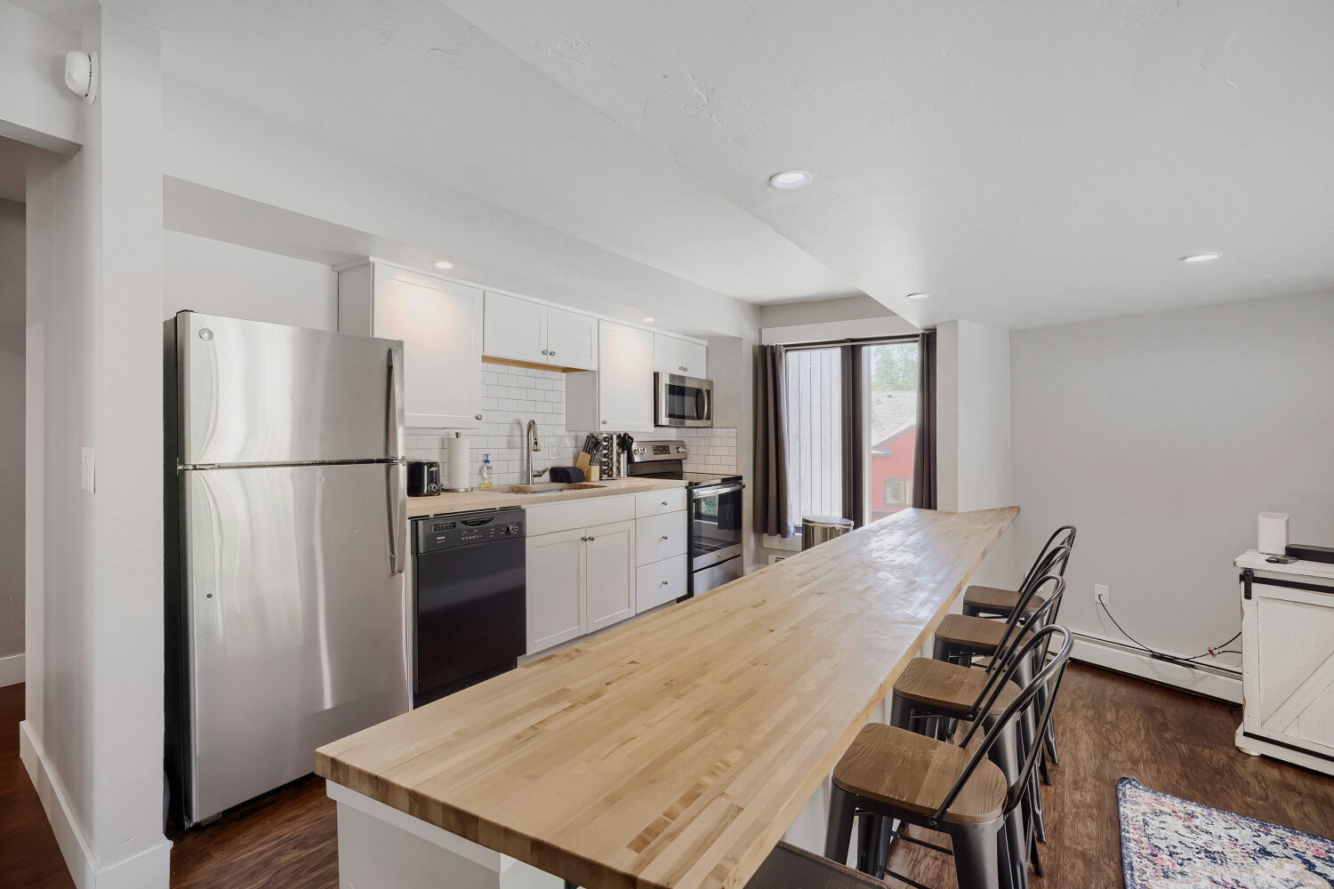 Your fully-equipped kitchen awaits with modern appliances and a spacious butcher-block island, perfect for preparing meals and gathering with loved ones.
