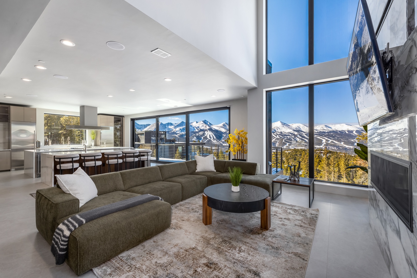 Stunning mountain vistas frame your modern retreat, where soaring ceilings and floor-to-ceiling windows create the perfect backdrop for relaxation.